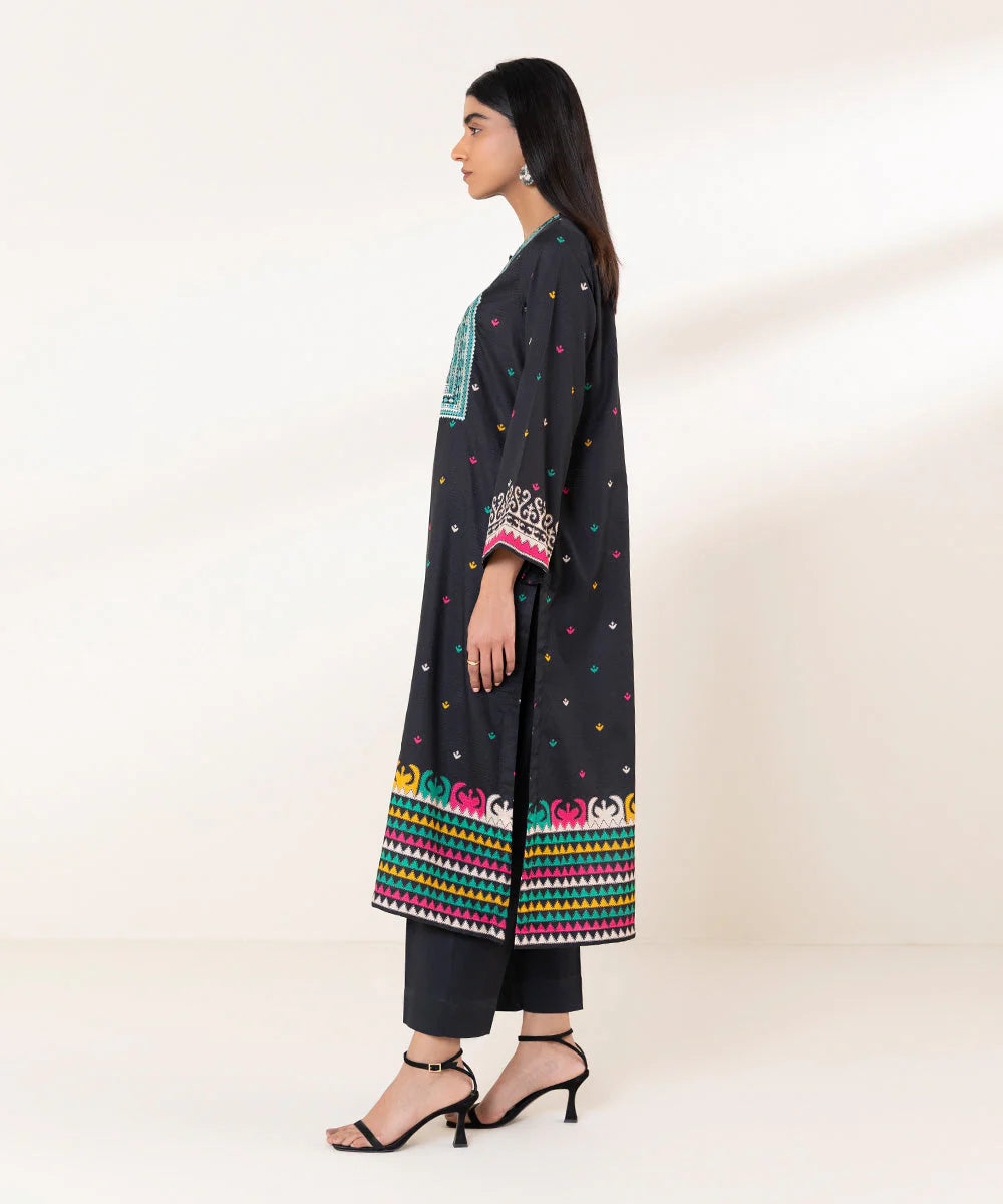 women showing side profile of a Pakistani suits Canada – Sapphire’s embroidered dobby shirt in black, highlighting premium fabric and exquisite embroidery.