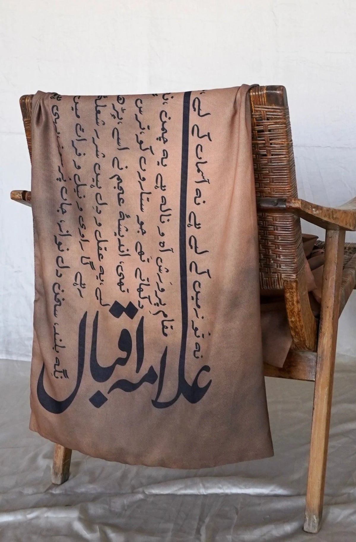 Manto Karvaan light brown textured polyester stole displayed on wooden chair - premium men's Pakistani accessory