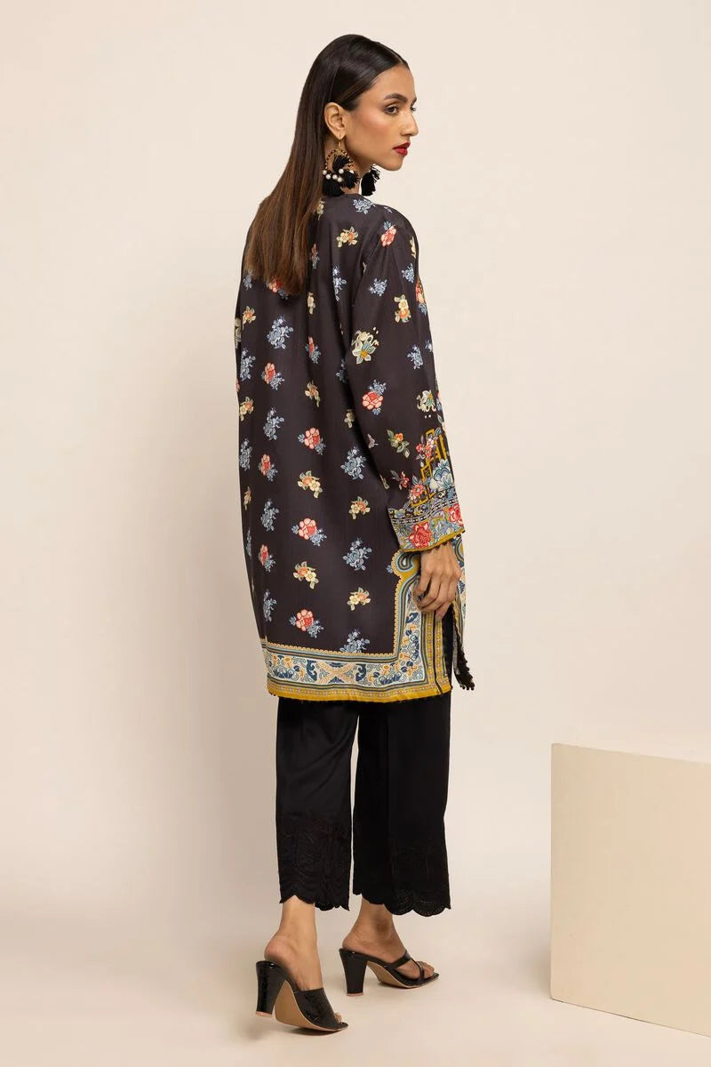 Rear view of a woman in a black Khaadi kurta, displaying its sleek fit and premium fabric – a must-have for traditional Pakistani clothes lovers.