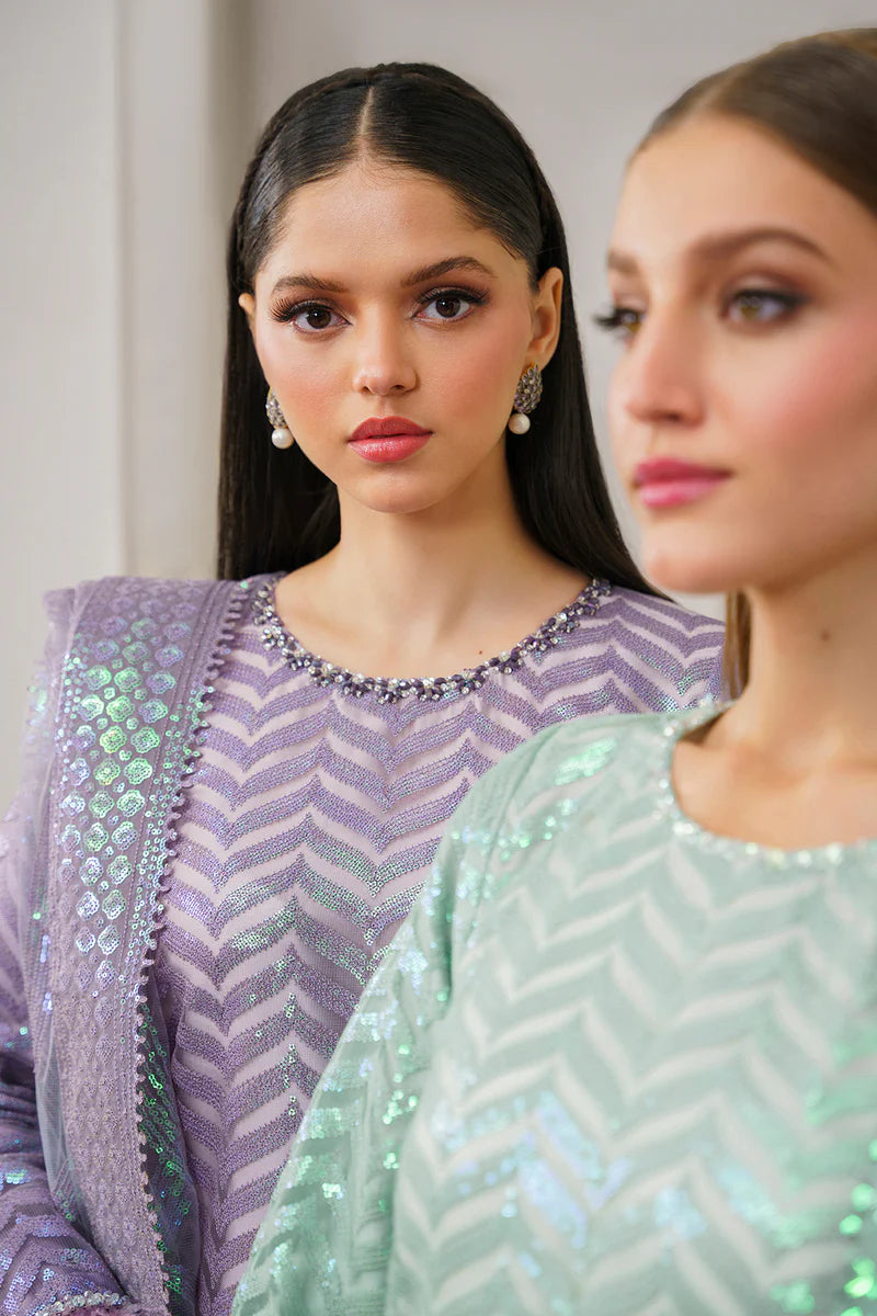 A close-up of Baroque’s embroidered net fabric, showcasing intricate detailing and fine craftsmanship in this Pakistani suit.
