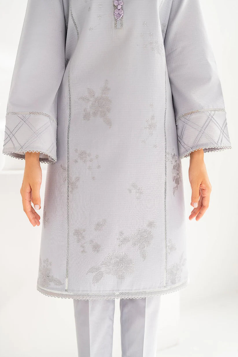 Detailed close-up of Jazmin’s embroidery on a grey synthetic organza fabric, showcasing fine craftsmanship in Pakistani suits online Canada.