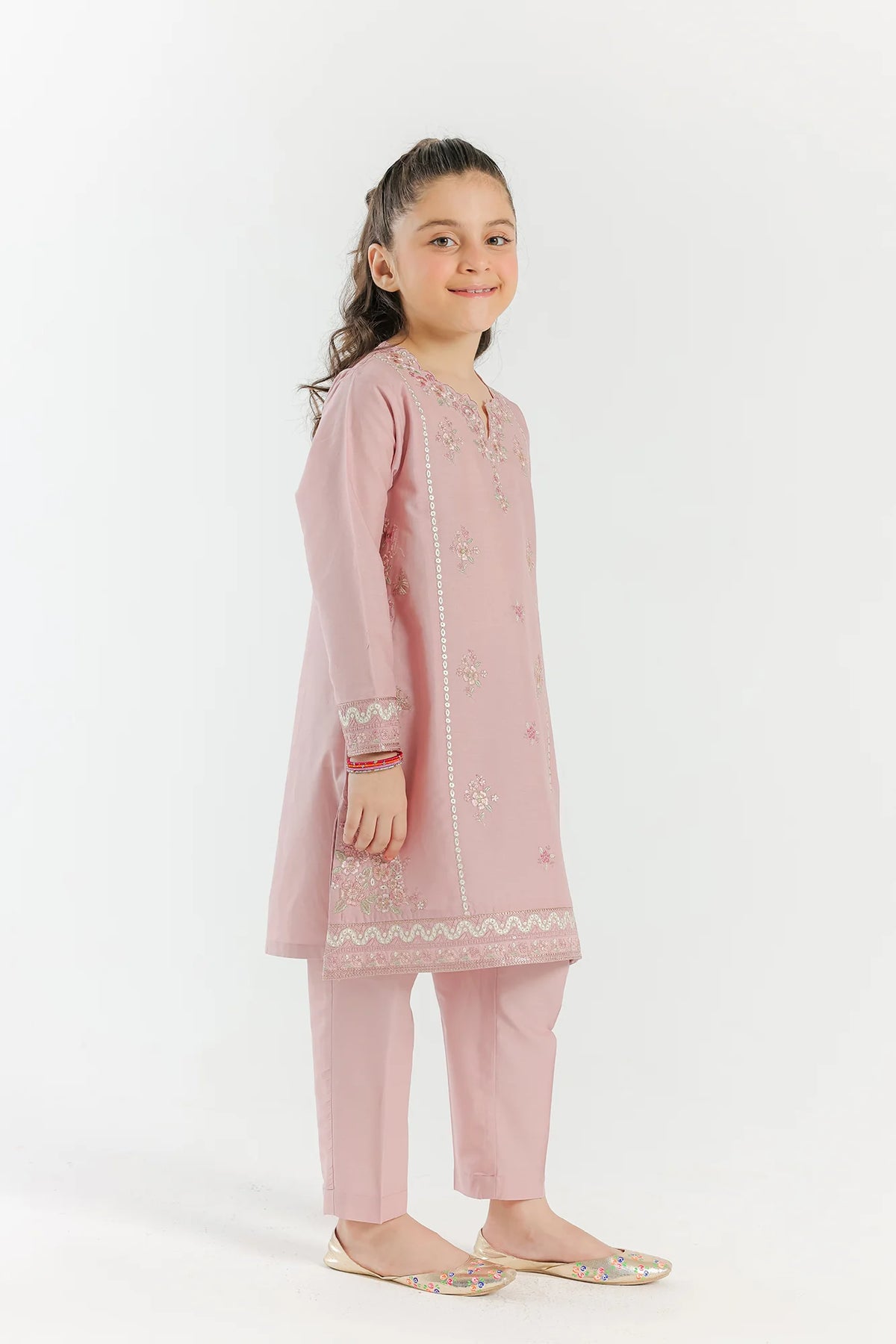 ethnic’s pale coral lawn suit, a stylish addition to Pakistani suits Canada for kids, featuring intricate embroidery for a chic look.