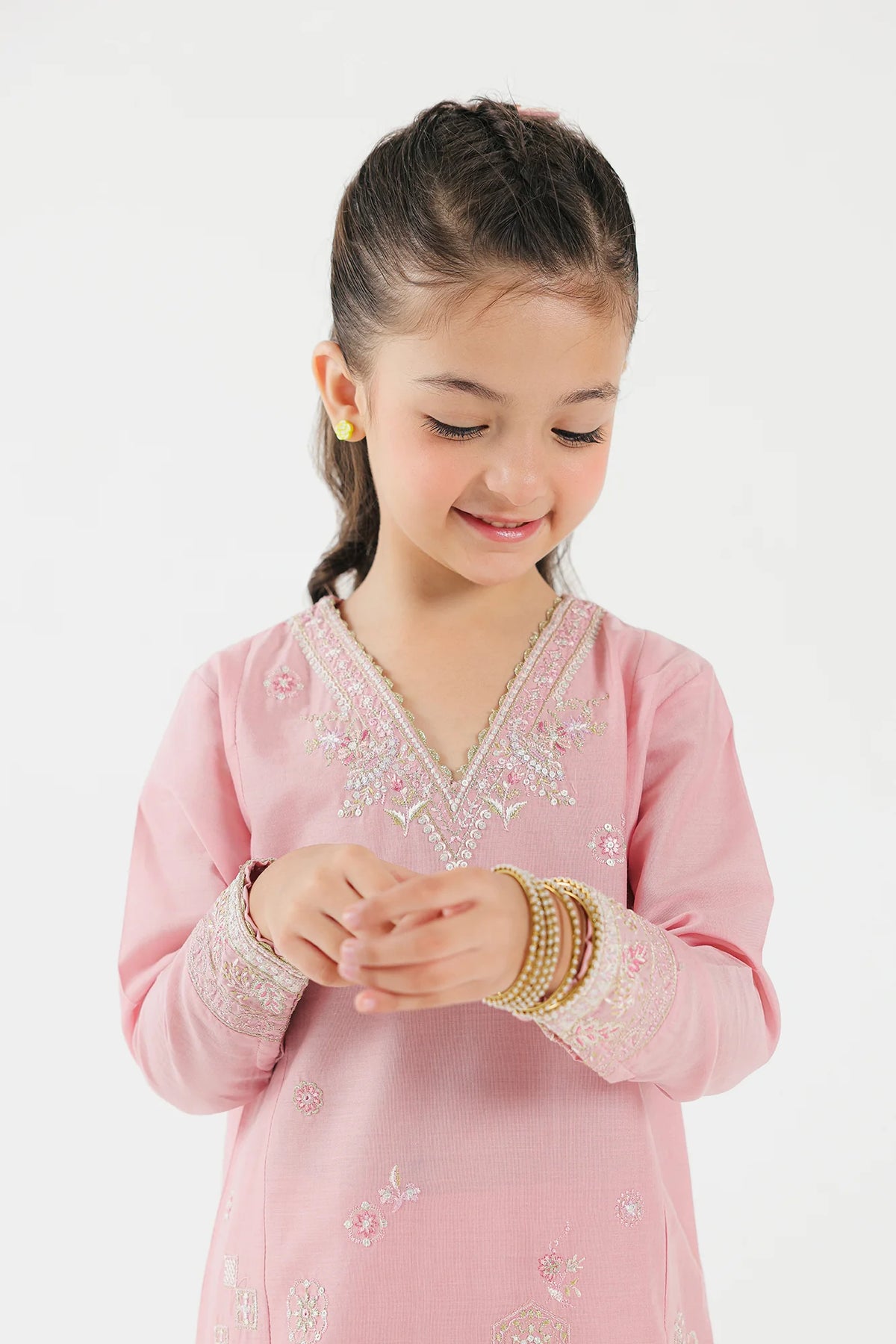 A close-up of the intricate embroidery on Ethnic’s pastel pink lawn suit, a must-have Pakistani suit for kids.