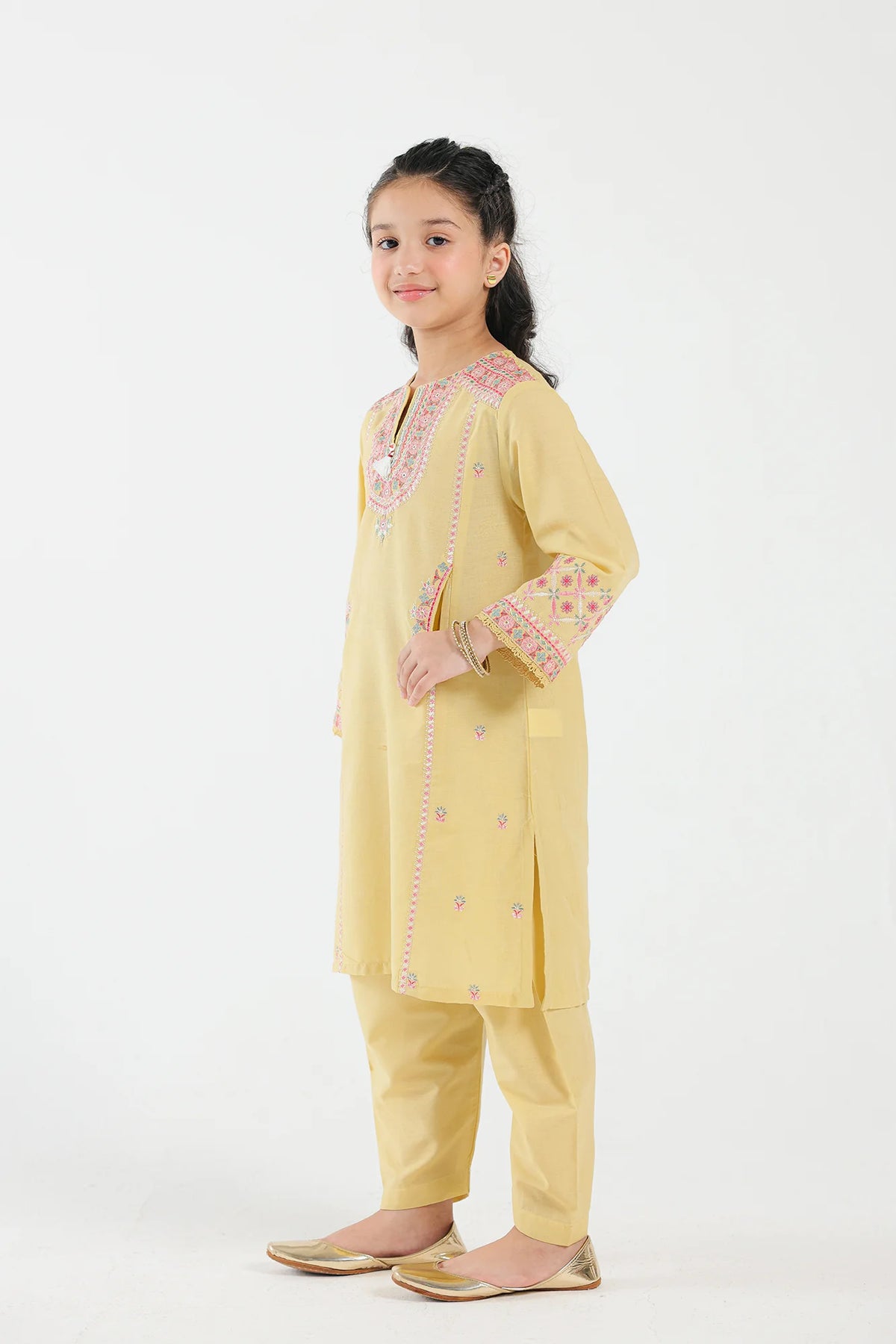 Side profile of Ethnic’s jacquard suit in bright yellow, showcasing intricate embroidery – a premium choice for Pakistani suits for kids.