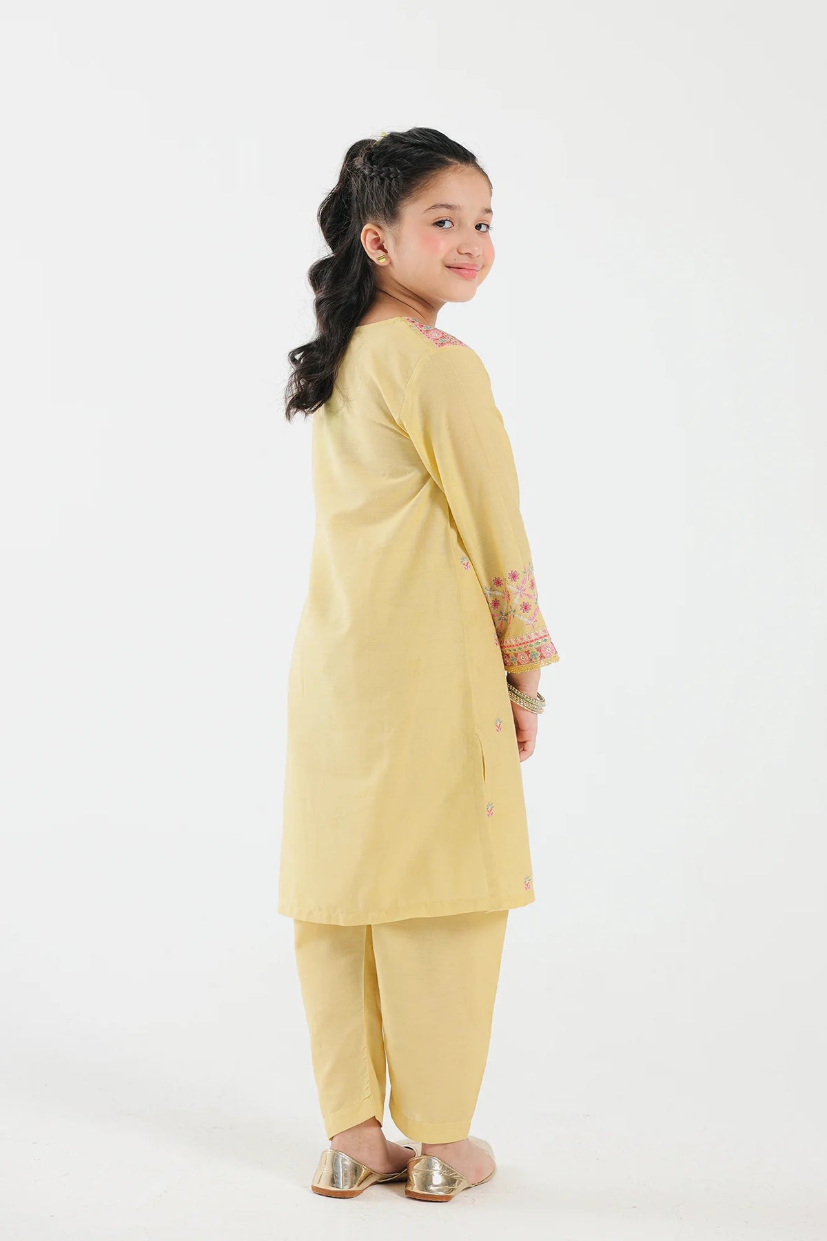 7-8 years old girl showing Back View of 
Elegant bright yellow jacquard suit from Ethnic, featuring a classic cut – explore Pakistani suits for kids in Canada.