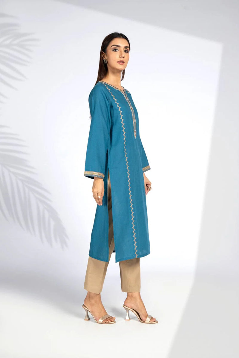 Side view of Chinyere’s teal blue cotton karandi shirt, showcasing soft fabric and intricate details – a must-have Pakistani suit for women.