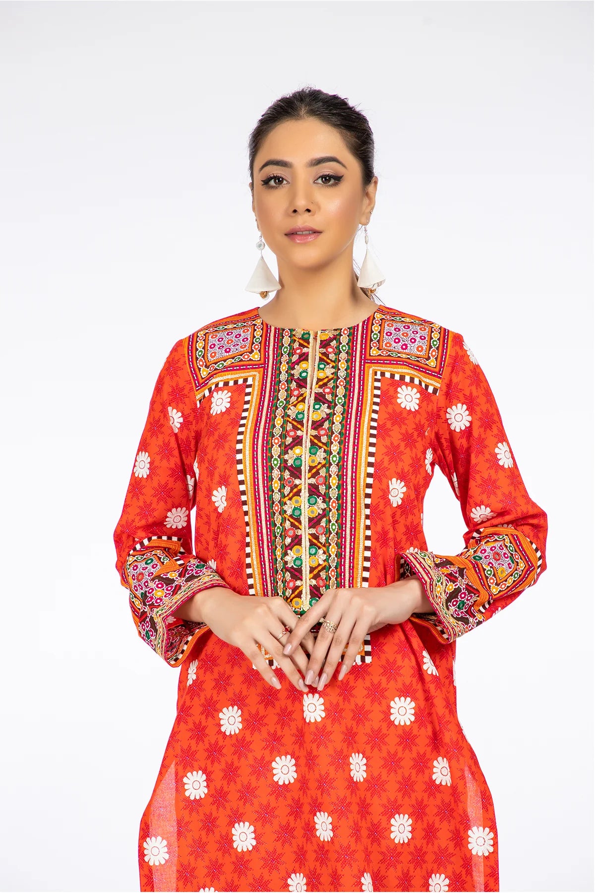 women showing Close-up of the premium cotton lawn fabric, showing the fine details of Kayseria’s Portland orange printed shirt, a staple in Pakistani suits Canada.