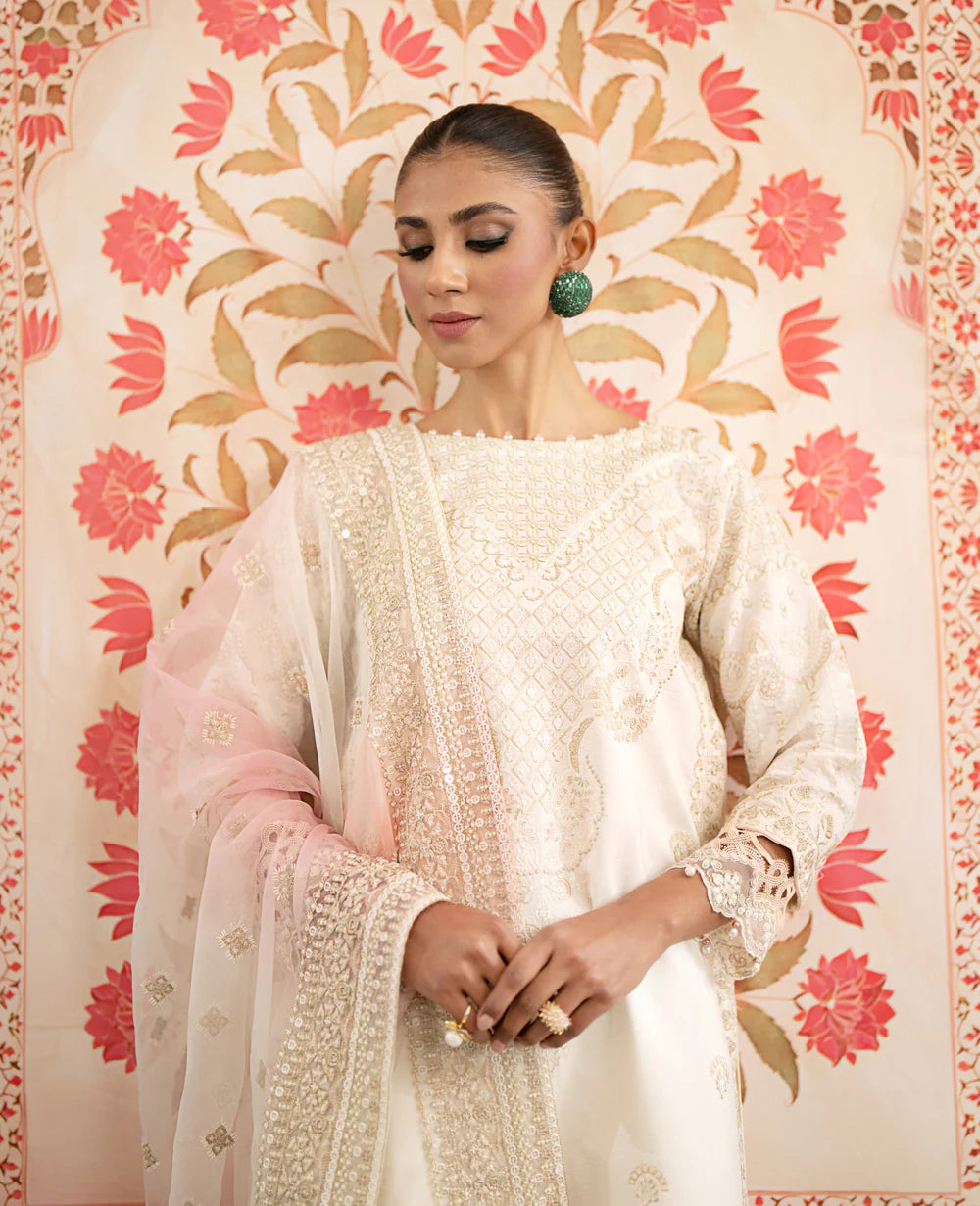 Side profile of Xenia’s off-white embroidered suit, showcasing intricate embroidery – an ideal Punjabi suit for women in Canada.