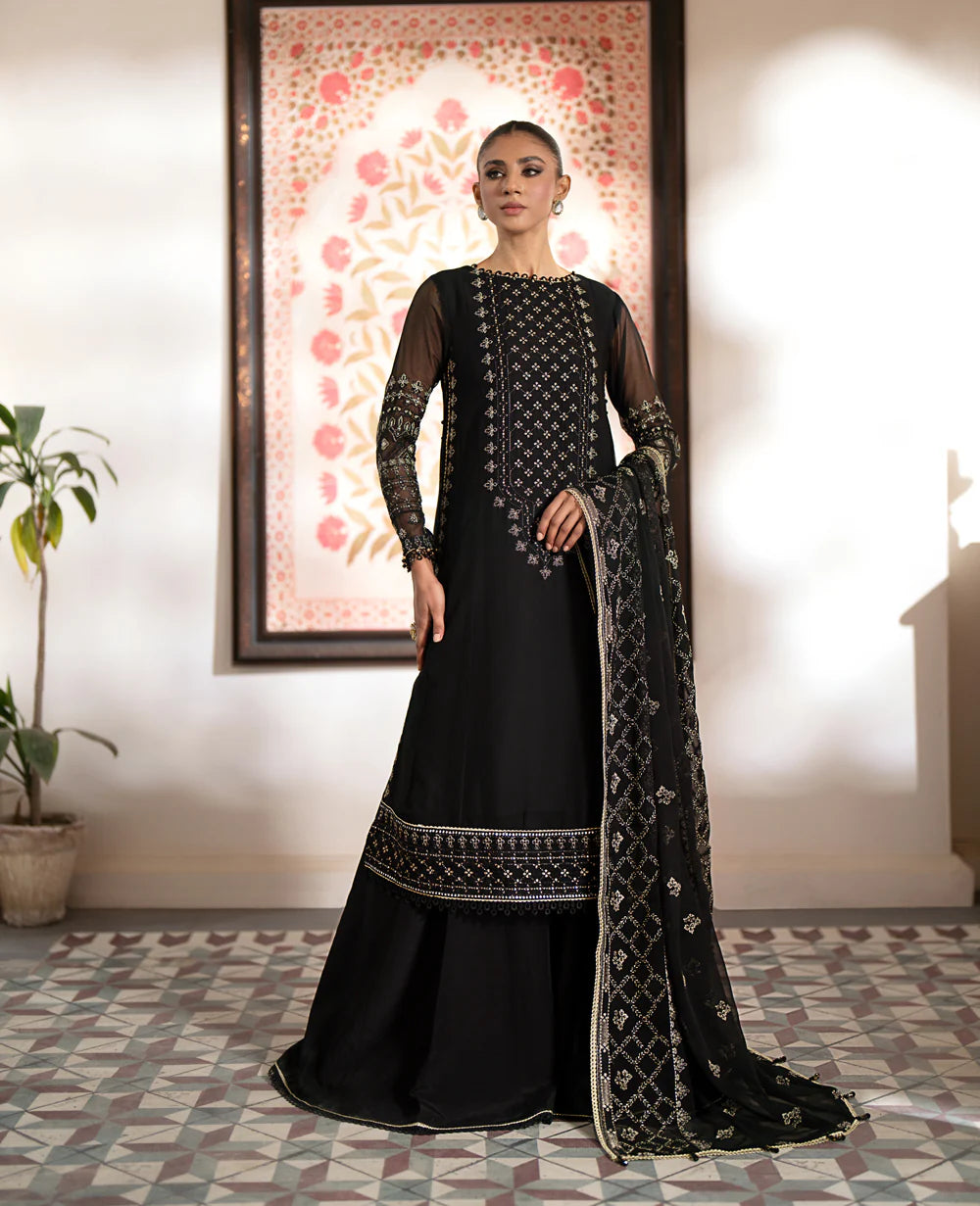 A woman wearing Xenia’s black chiffon embroidered suit – a perfect choice for Pakistani suits online in Canada, featuring premium raw silk trousers.