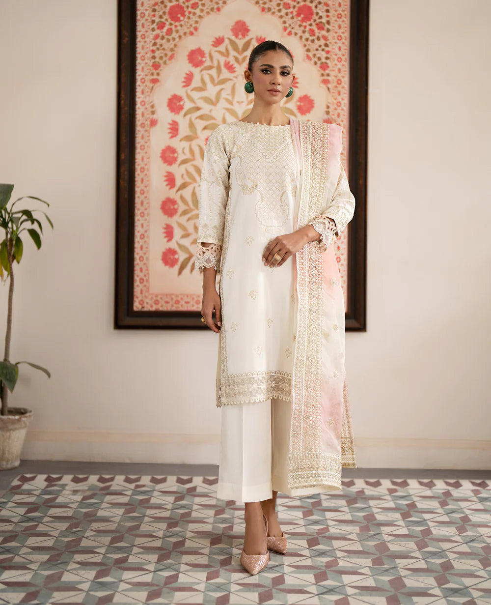 women wearing Xenia off-white embroidered Korean raw silk suit – a luxurious choice for Pakistani suits online in Canada, featuring elegant craftsmanship.