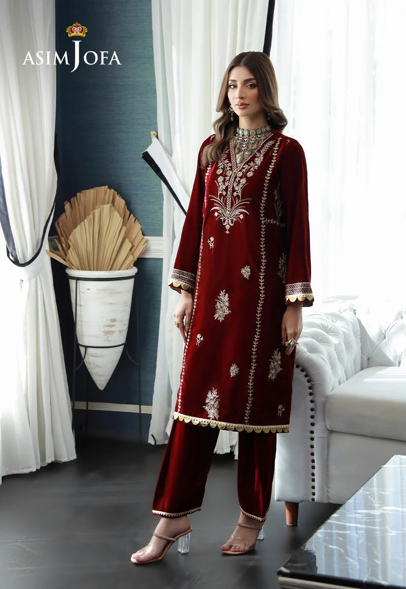 Large size woman wearing maroon embroidered velvet outfit by Asim Jofa – a luxurious pick for traditional Pakistani clothes lovers.