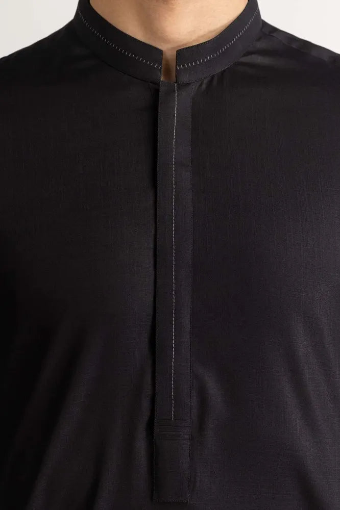 Detailed texture of GulAhmed’s black cotton suit, highlighting its premium fabric – a must-have Pakistani suit in Canada.