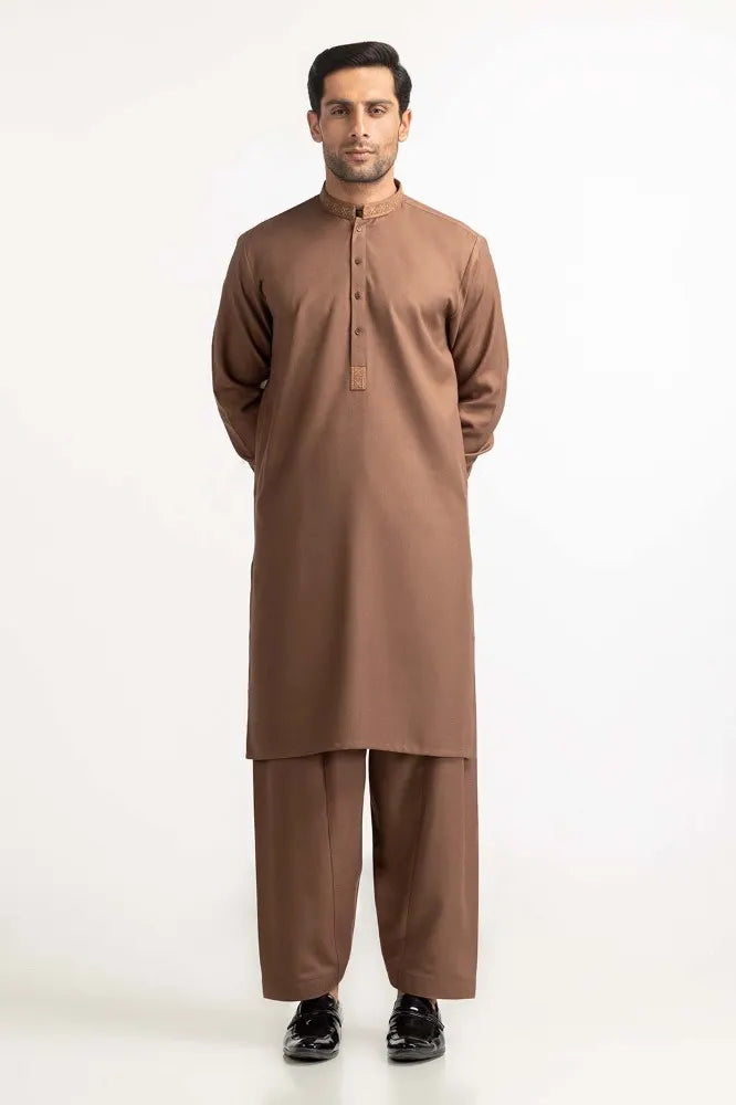 Side profile of GulAhmed’s brown suit, showcasing intricate embroidery – a premium option for Pakistani suits for men in Canada.