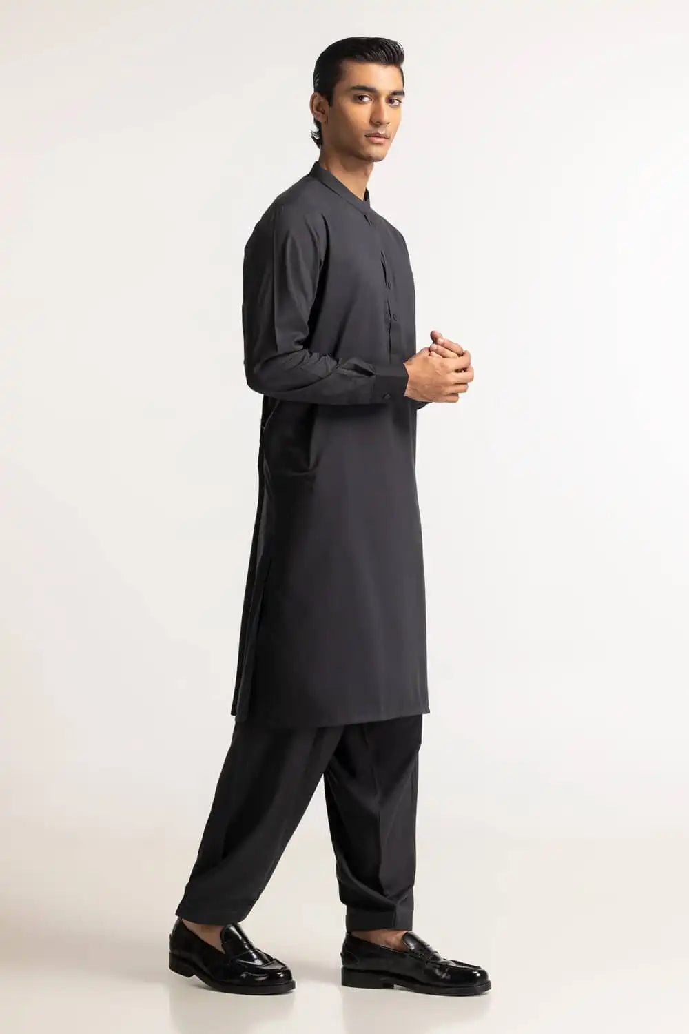 Side profile of GulAhmed’s charcoal suit, crafted for men who prefer timeless Pakistani suits for men in Canada.