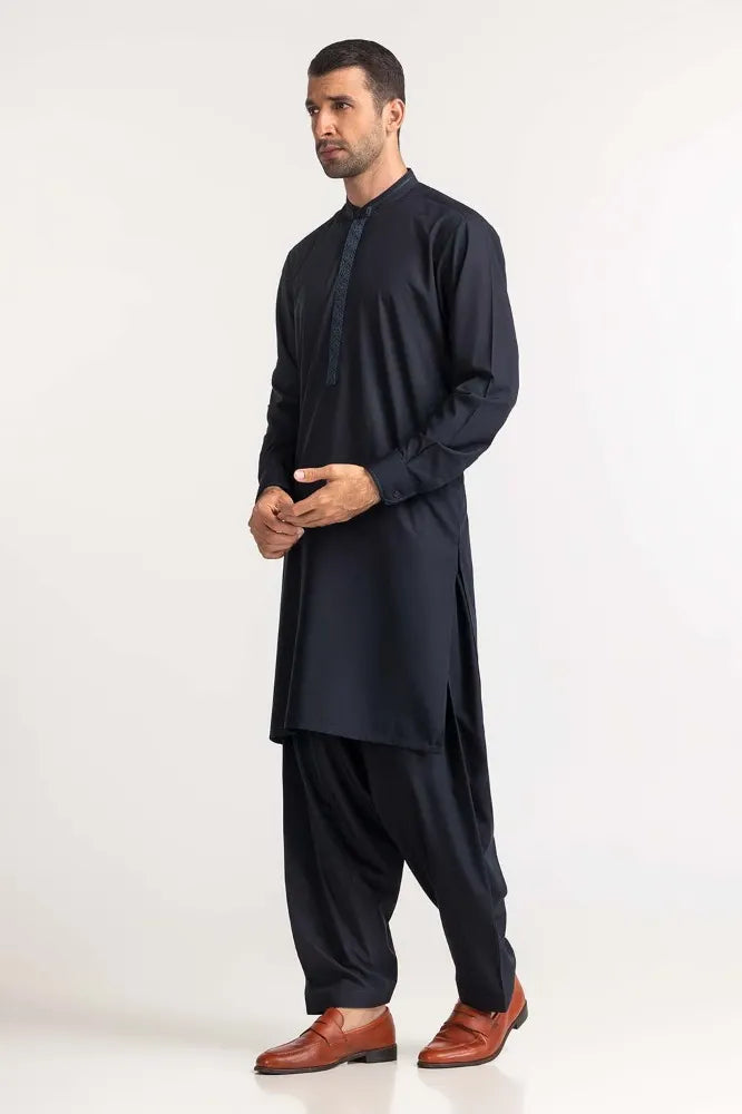 Side profile of GulAhmed’s navy blue suit, showcasing intricate embroidery – a premium option for Pakistani suits for men in Canada.