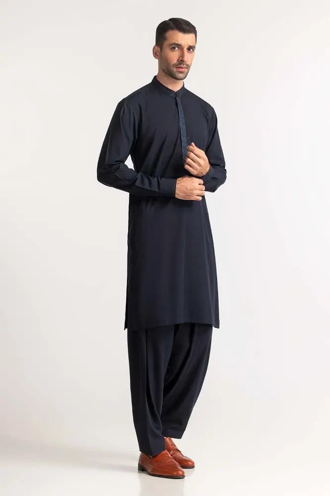 Pakistani suits in Canada – GulAhmed’s navy blue embroidered suit features fine craftsmanship and a timeless design for men’s fashion.