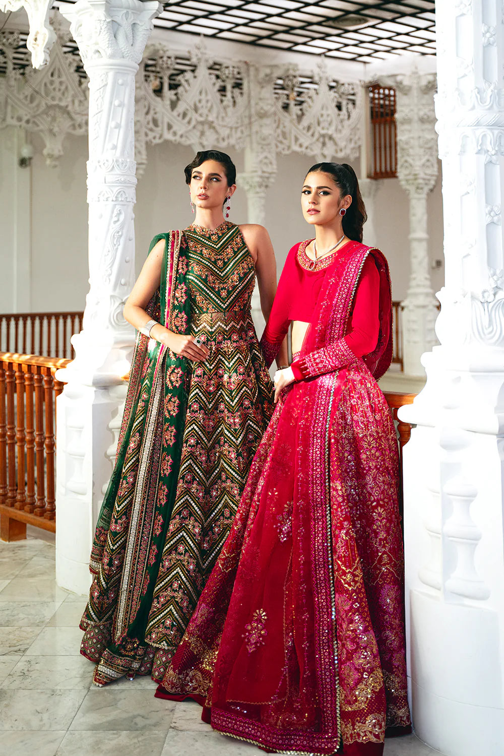 Saira Rizwan bridal collection comparison - fuchsia pink and green designer lehengas - Pakistani wedding suits Canada traditional architecture.