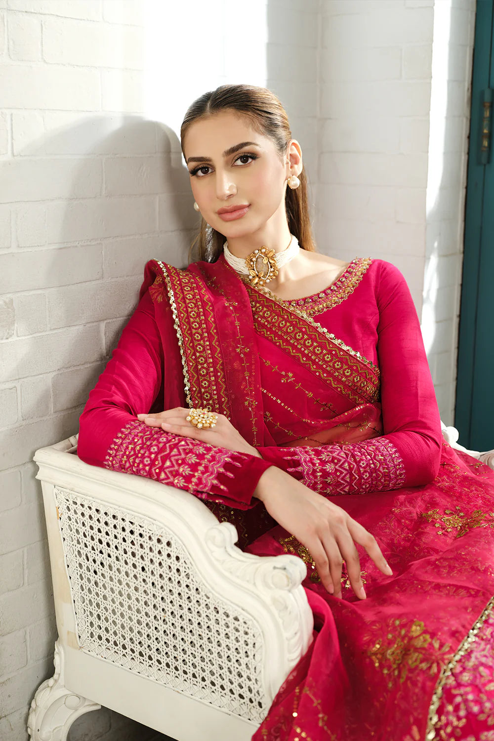 Saira Rizwan designer bridal lehenga seated pose - fuchsia pink choli with organza dupatta - Pakistani wedding dress online Canada