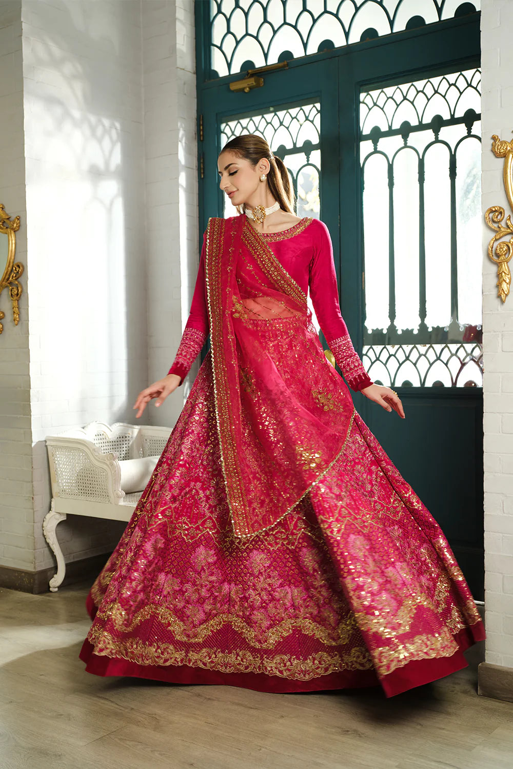 Saira Rizwan bridal outfit twirl pose - fuchsia pink lehenga with flowing dupatta movement - Pakistani wedding suit dynamic shot Canada.