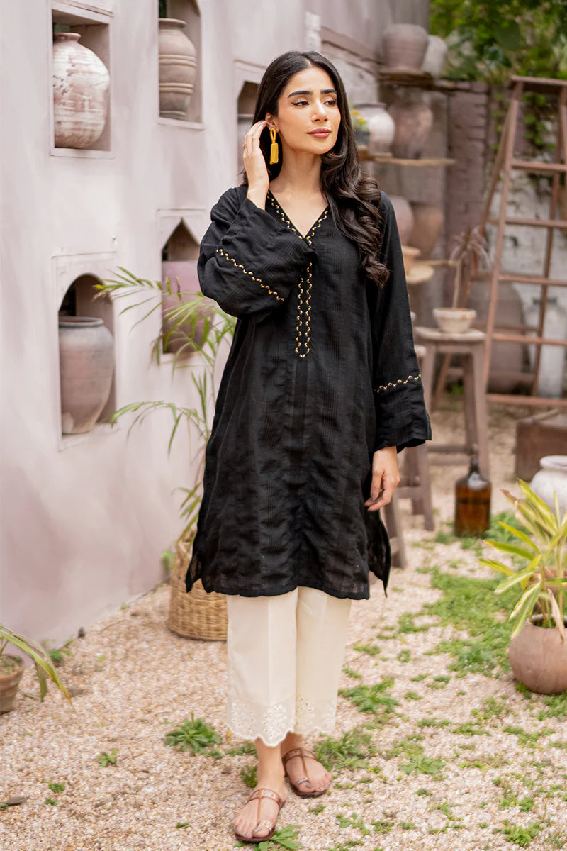front profile of Armaas’ embroidered black lawn shirt, showcasing fine details – a must-have in Pakistani suits for women.