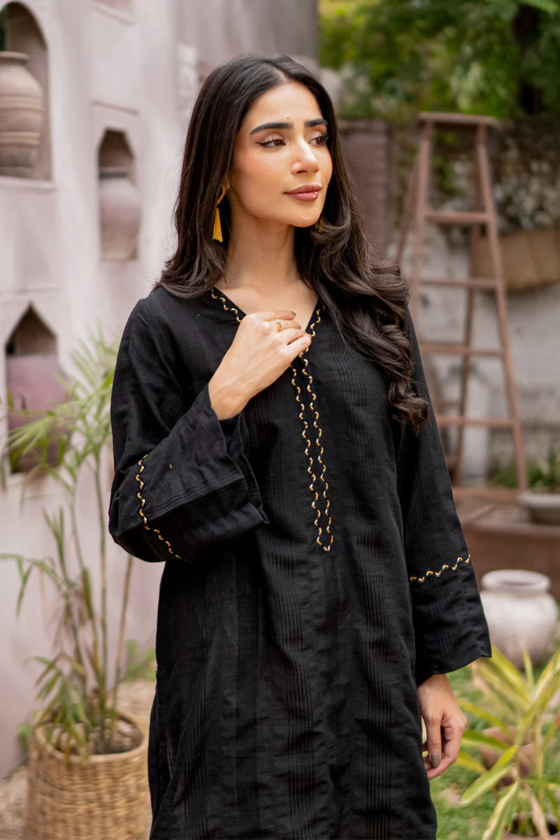 Side profile of Armaas’ embroidered black lawn shirt, showcasing fine details – a must-have in Pakistani suits for women.