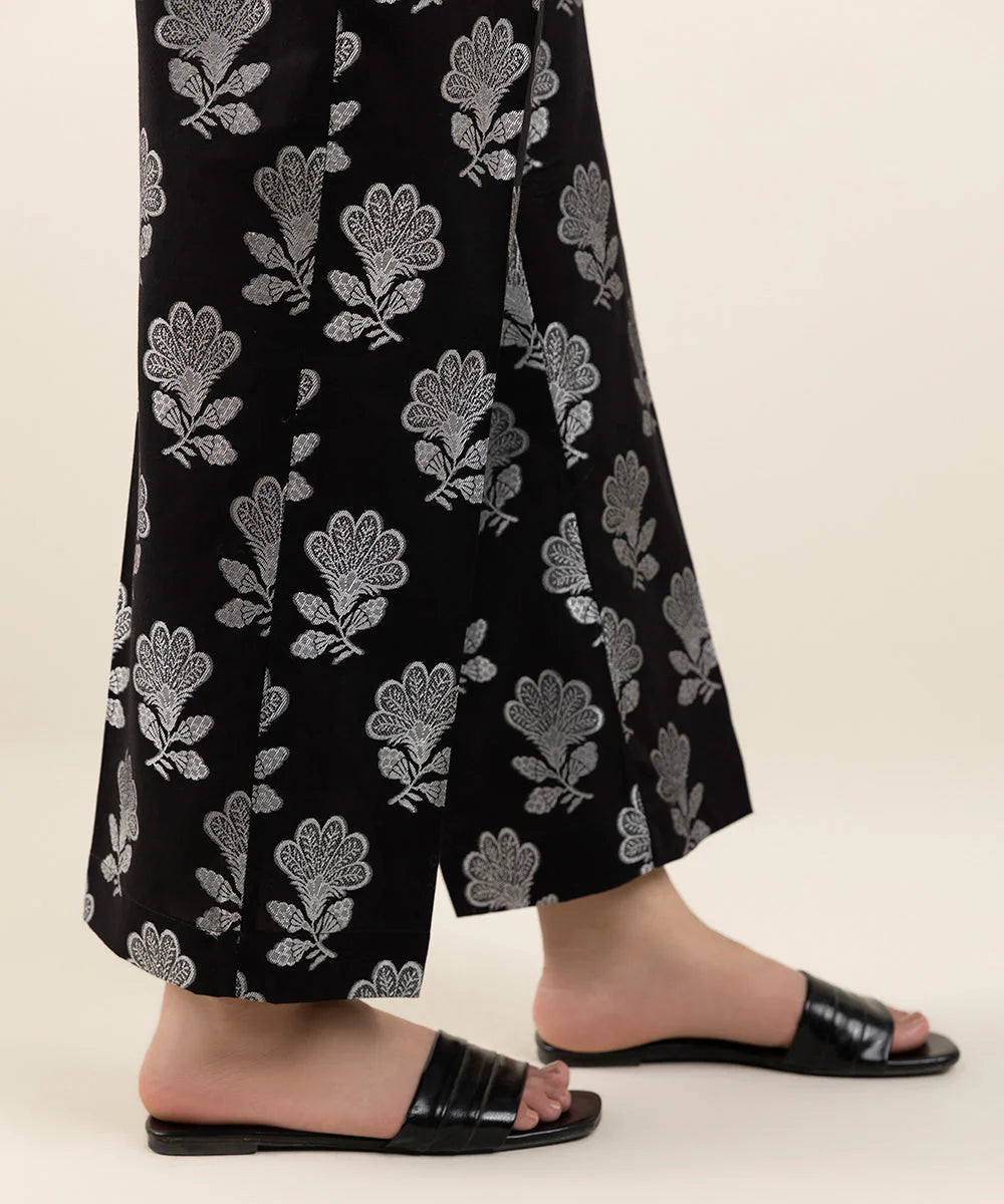 women showing Elegant black jacquard straight pants by Sapphire – a must-have for Pakistani suits online in Canada, perfect for casual wear.