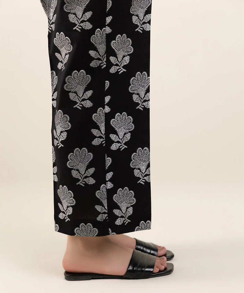 side view of a Black straight pants from Sapphire, showcasing intricate jacquard texture – a premium addition to Pakistani suits in Canada.