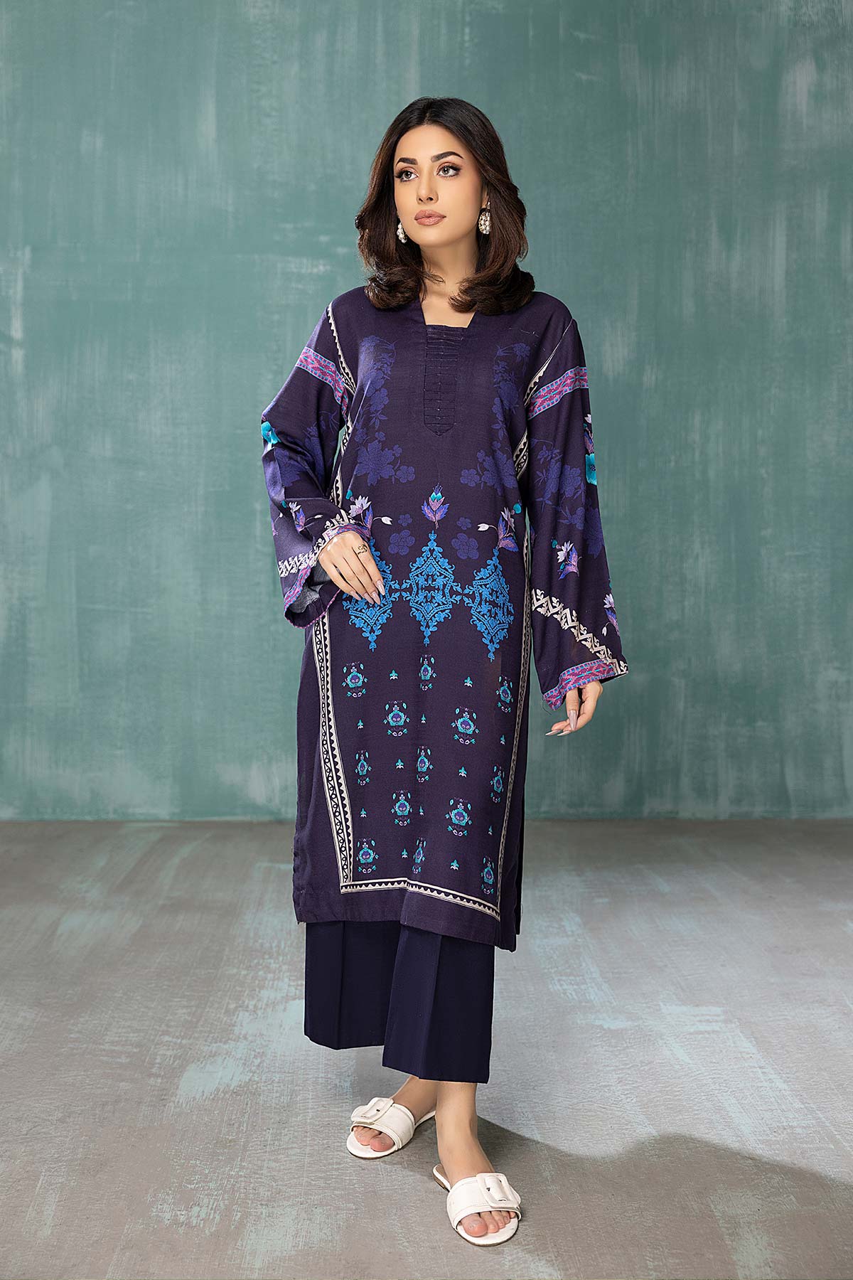 women showing front view of a navy blue lawn shirt by Charizma, a must-have for Punjabi suits lovers in Canada.