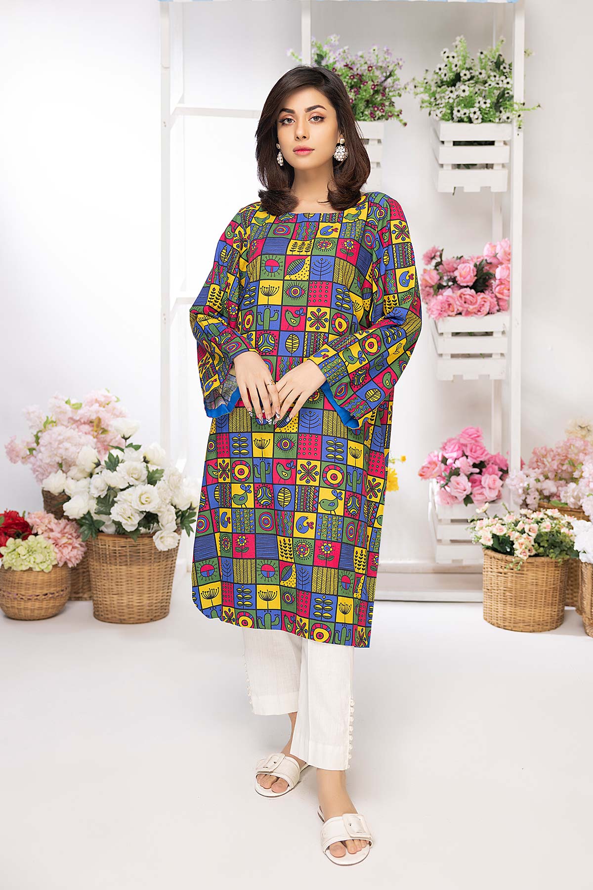 A woman wearing a Charizma printed Brosha lawn shirt, a top choice for Pakistani suits online in Canada, designed for casual elegance.
