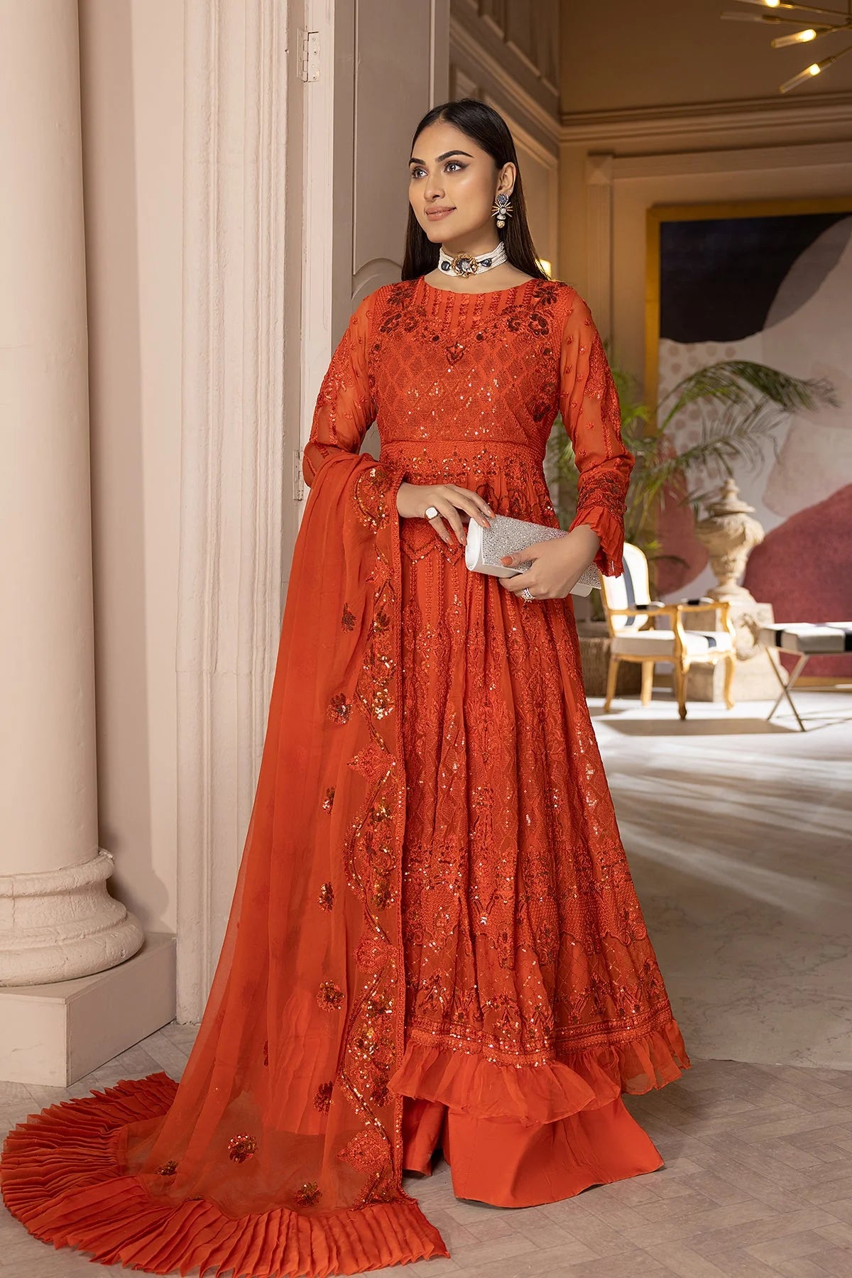 Discover top-quality Pakistani suits with this stunning orange sharara set from Charizma, ideal for weddings and festive gatherings.