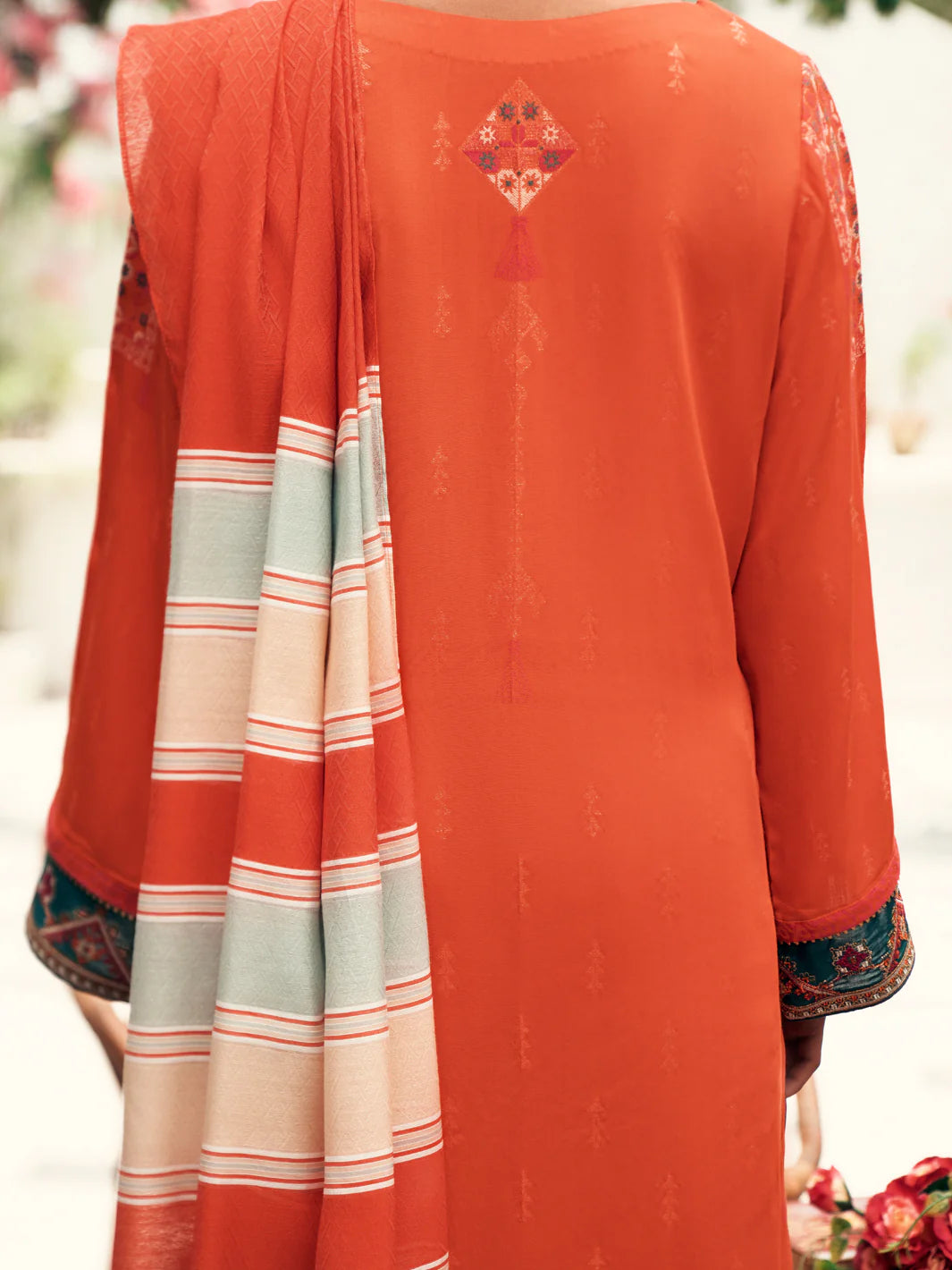Rear view of the orange jacquard suit by Almirah, a sophisticated addition to Pakistani suits for women in Canada.