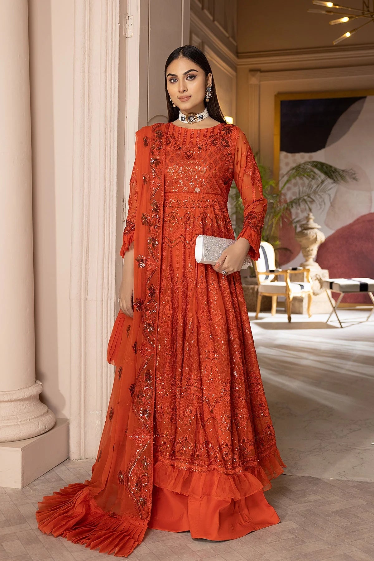 This premium Charizma Pakistani suit features intricate sequin embroidery on chiffon and silk, offering a luxurious formalwear look.