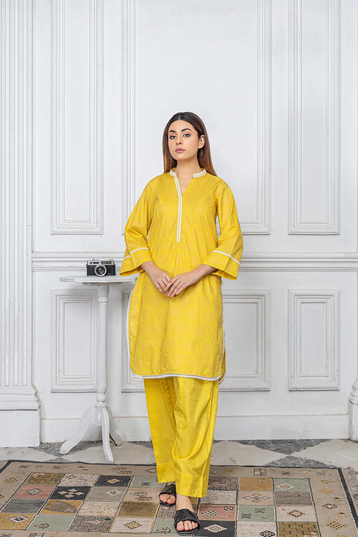 women wearing a Charizma yellow tabel print lawn shirt – a stylish choice for Pakistani suits online in Canada, made from luxurious raw silk.
