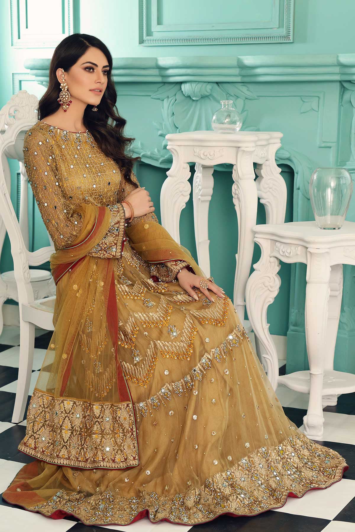 WOMEN SITTIN WEARING Pakistani suits in Canada – Charizma’s golden 3PC suit features exquisite adda work, making it perfect for formal wear.