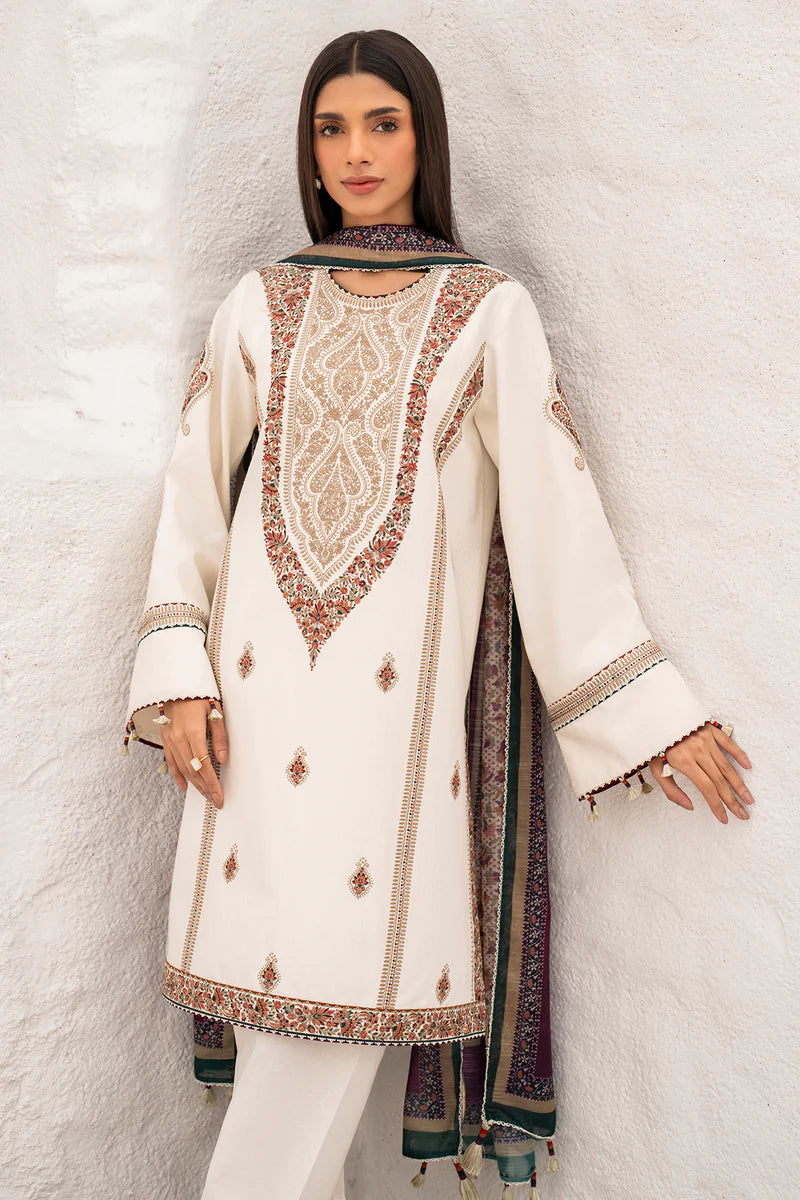 Woman wearing a cream embroidered traditional outfit against a white background of Pakistani dresses in Canada