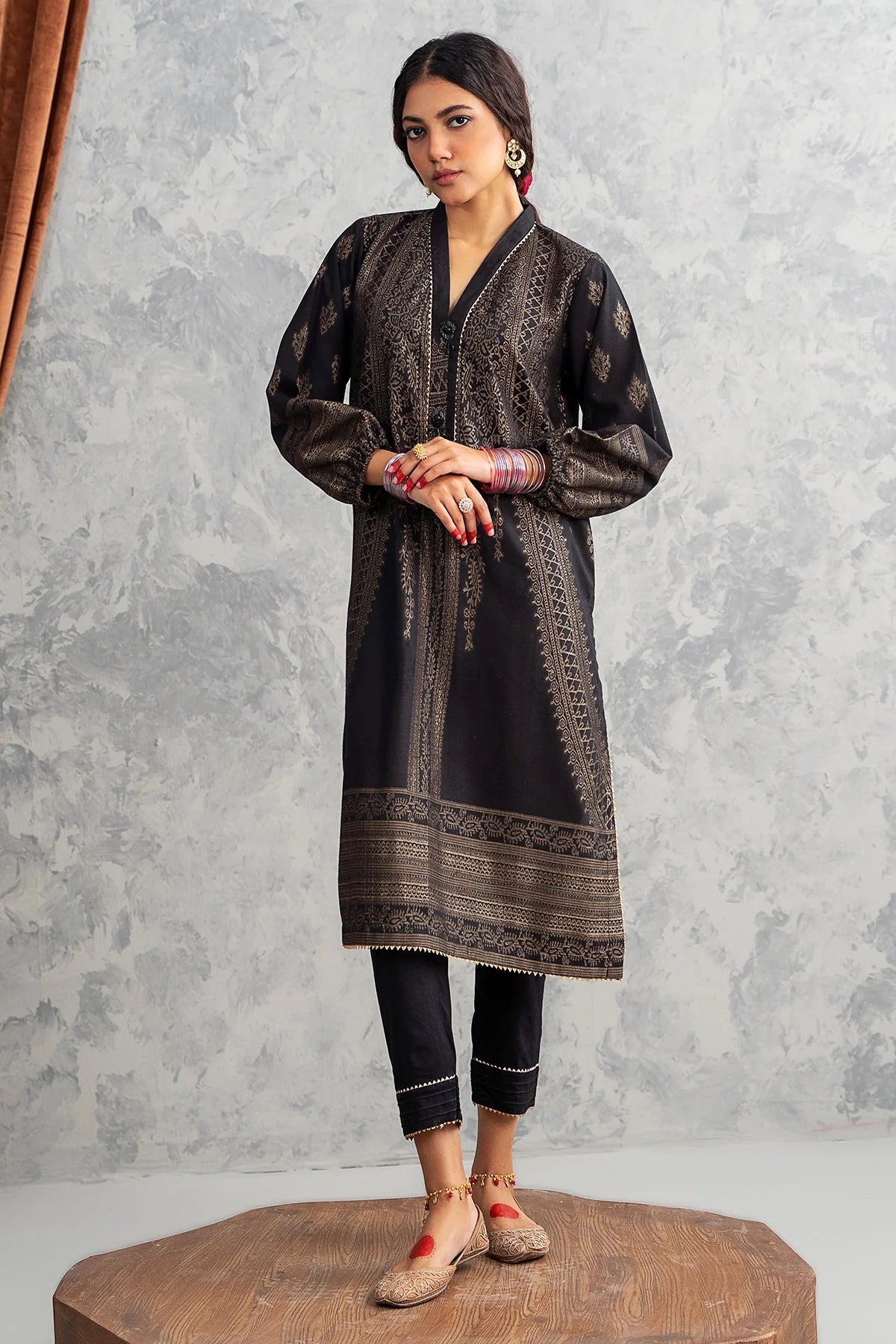 Women wearing Charizma’s black khaddar brosha printed shirt – a must-have for Pakistani suits in Canada, ideal for casual occasions.