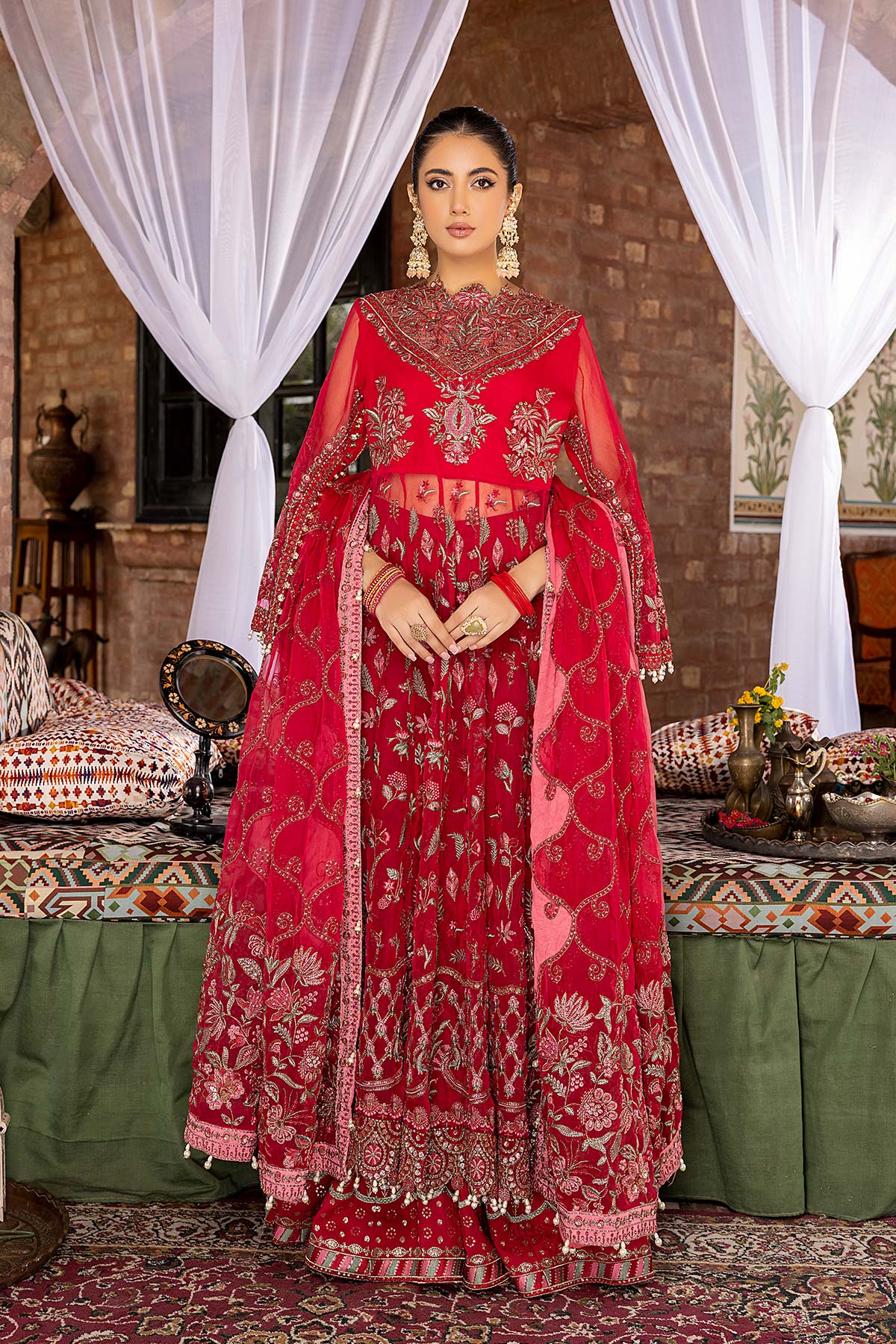 front view of a women wearing Charizma red embroidered organza maxi – a stunning choice for Pakistani suits online in Canada, perfect for formal wear.