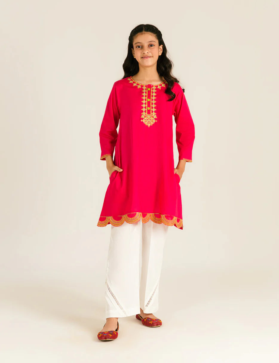A young girl (11-12 years old) wearing a pink embroidered tunic suit from Beechtree – a stylish choice for Pakistani suits online in Canada.