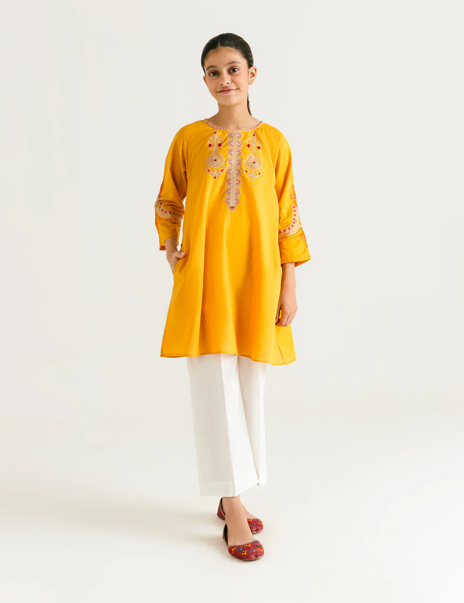 A 13-14-year-old girl wearing a Beechtree yellow embroidered lawn kurta – a perfect choice for Pakistani suits online in Canada.