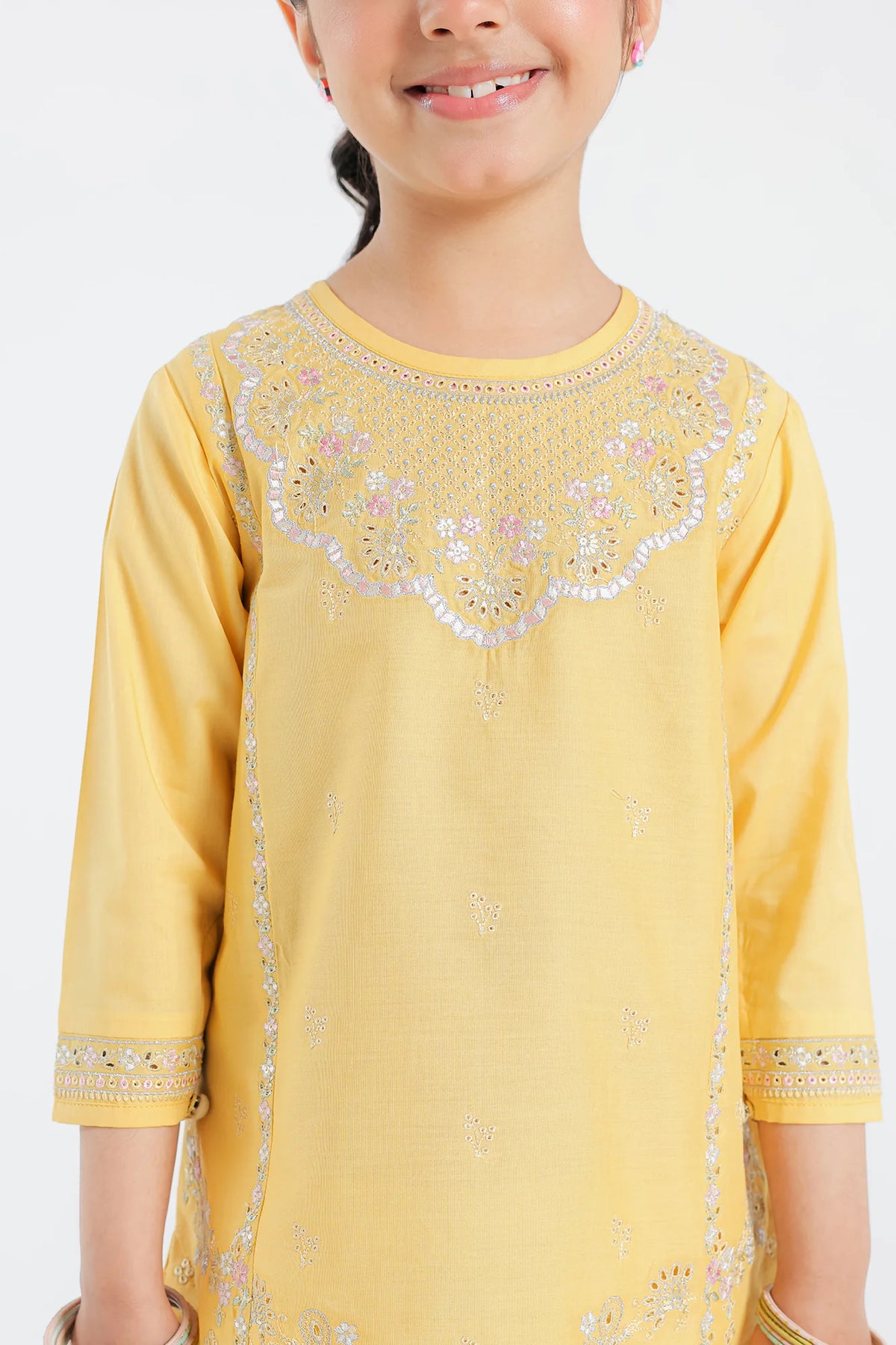 Intricate embroidery close-up of Ethnic’s yellow lawn suit – a premium addition to Pakistani suits for kids in Canada.
