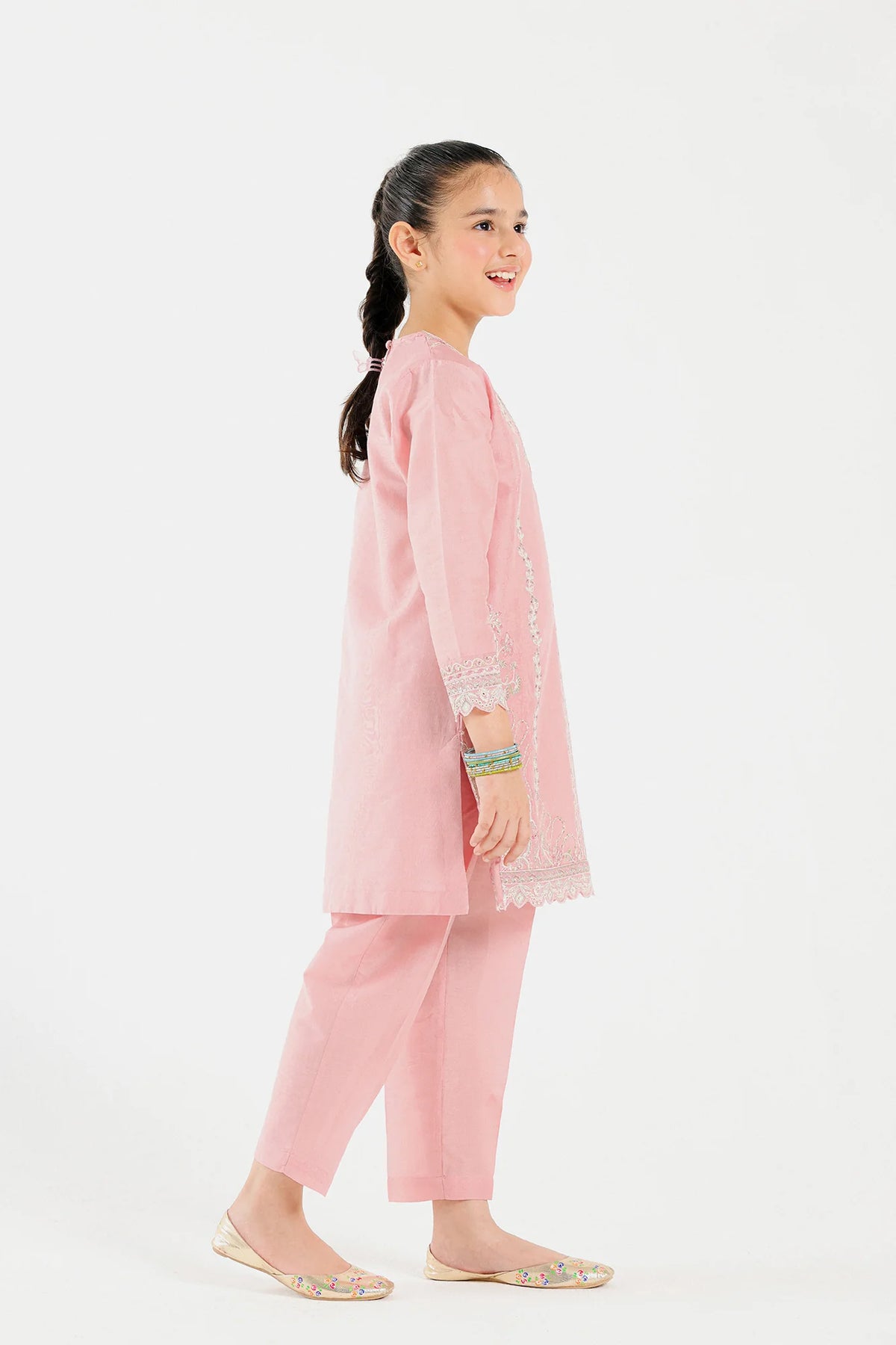  Close-up of Ethnic’s premium lawn fabric in a powder coral embroidered 2 PC suit for kids.