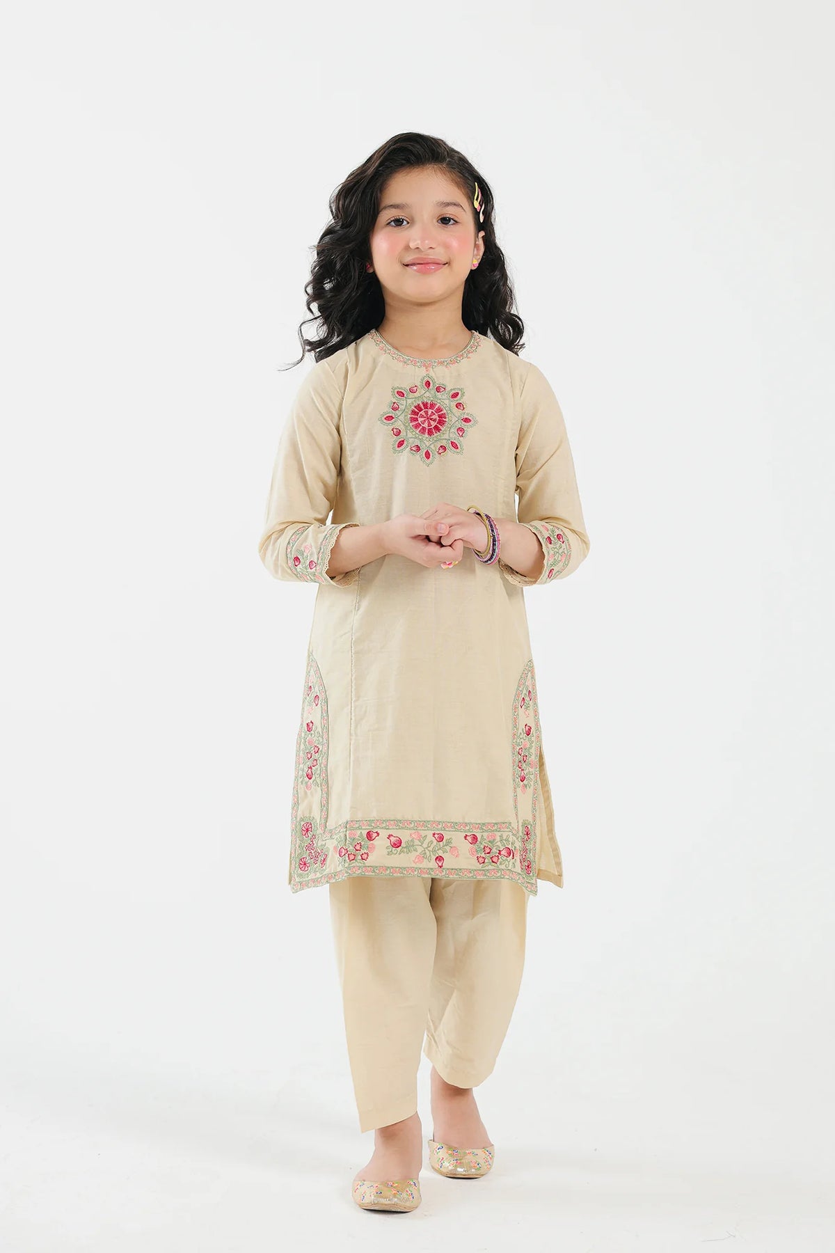 A 11-12 years old girl wearing a bright yellow embroidered jacquard suit from Ethnic – perfect for Pakistani suits online in Canada.