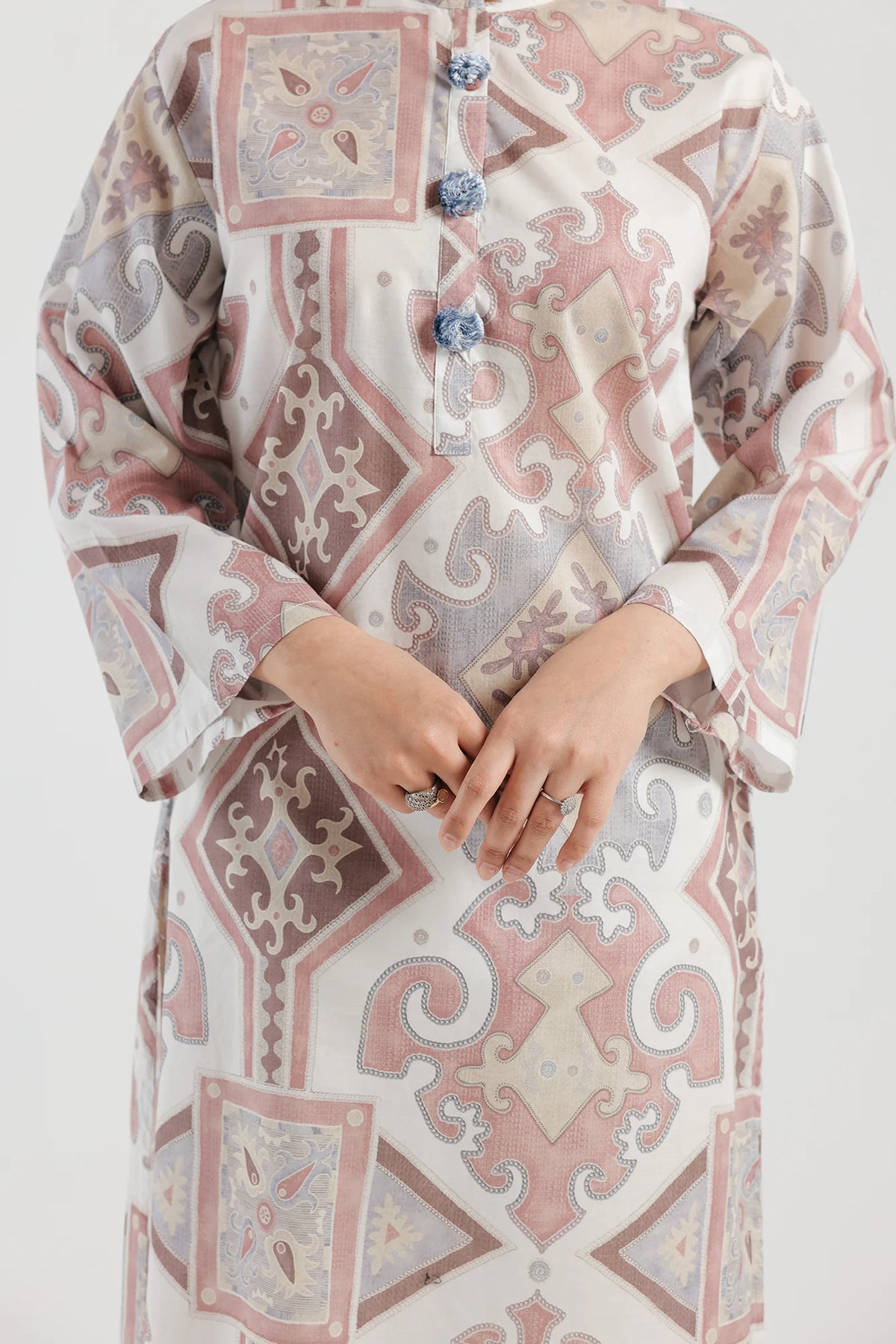 Detailed close-up of Ethnic’s printed lawn shirt in tea pink, highlighting soft fabric texture and intricate button detailing.