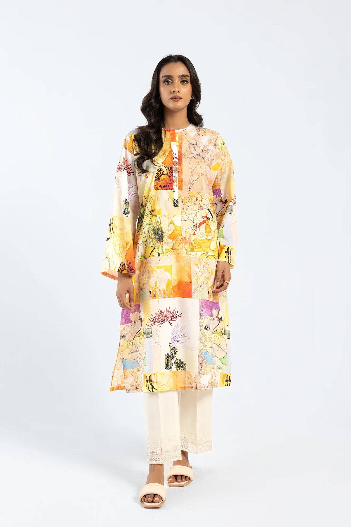 A woman wearing a pale yellow printed cotton shirt from Ethnic, a top choice for Pakistani suits online in Canada.