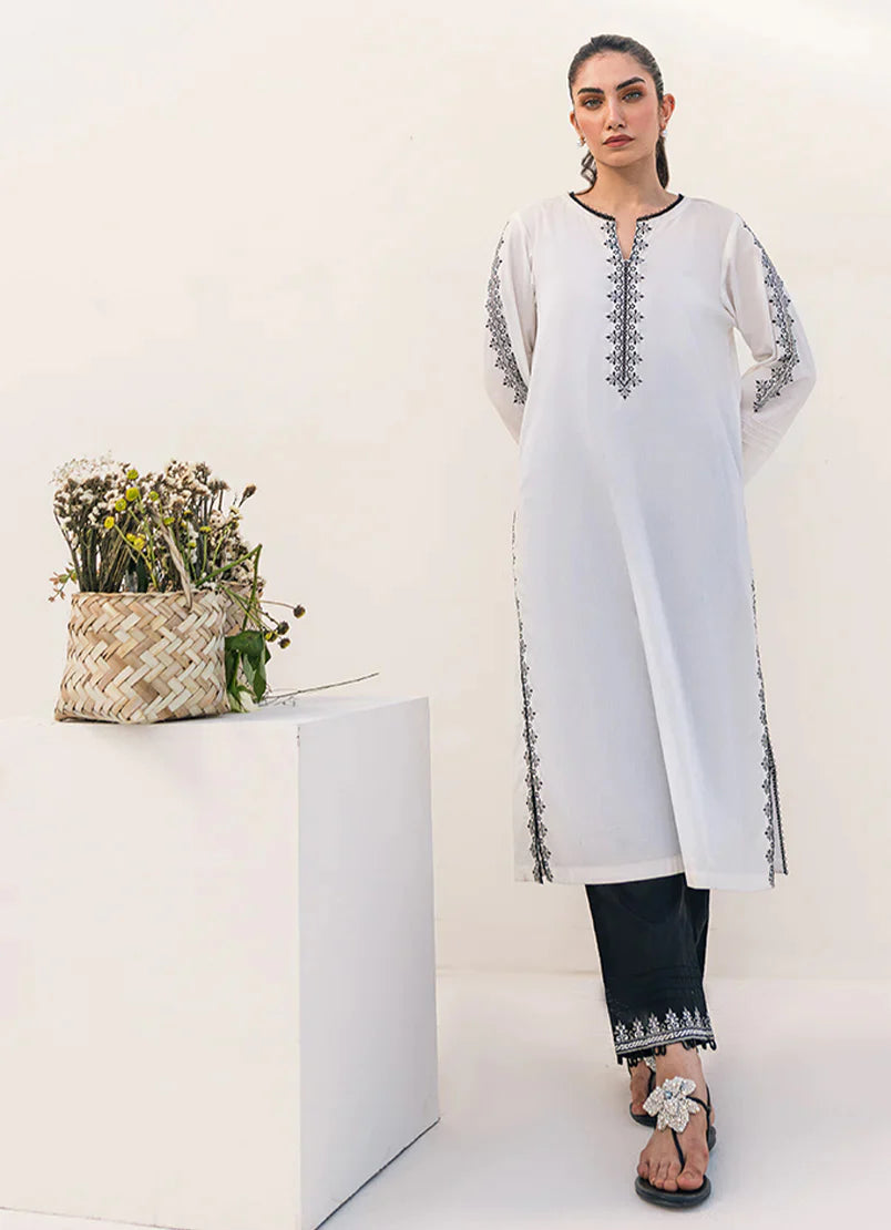 Front View of embroidered white and black 2 PC cotton co-ord set for women, featuring intricate neckline embroidery – Traditional Pakistani clothes.