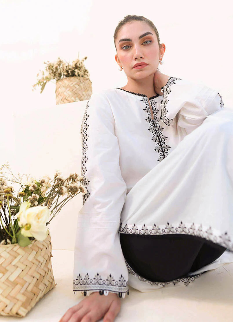 Close-up of Cotton fabric close-up showcasing intricate embroidery details on the shirt and trousers – 100% original Image brand.