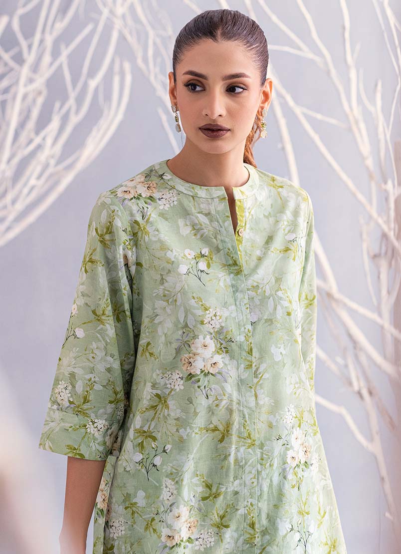  A woman wearing a medium-size Image co-ord set, highlighting vibrant traditional Pakistani clothes.