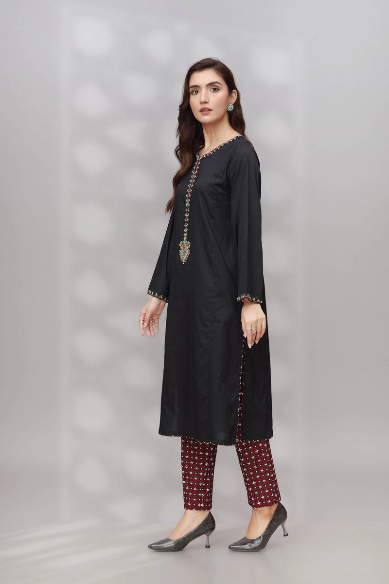 Side profile of Chinyere’s black dobbi suit, showcasing its fine tailoring – a must-have for Punjabi suits in Canada.