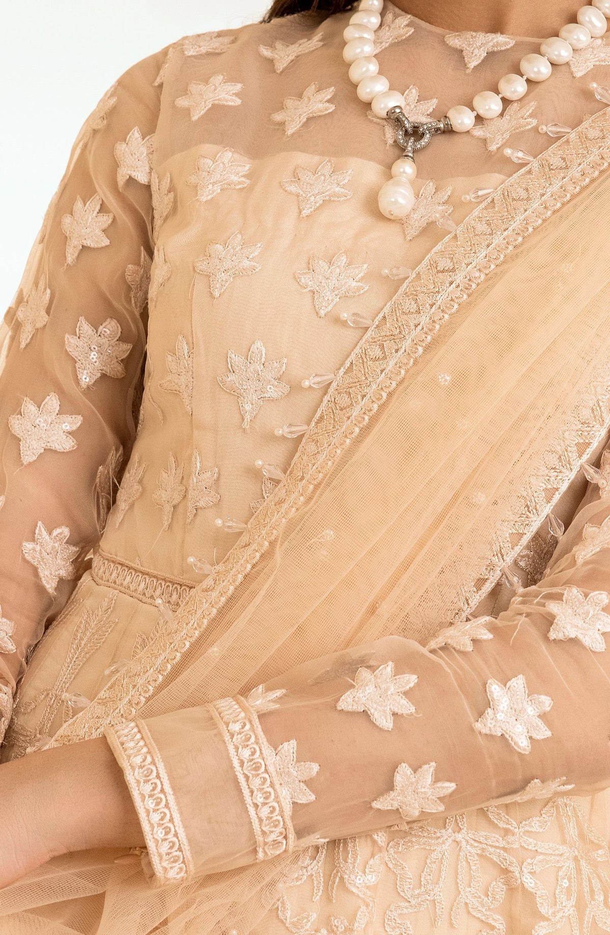 wedding model showing Detailed embroidery on Maryum & Maria’s peach maxi dress – a breathtaking choice for wedding wear from Pakistani suits Canada.