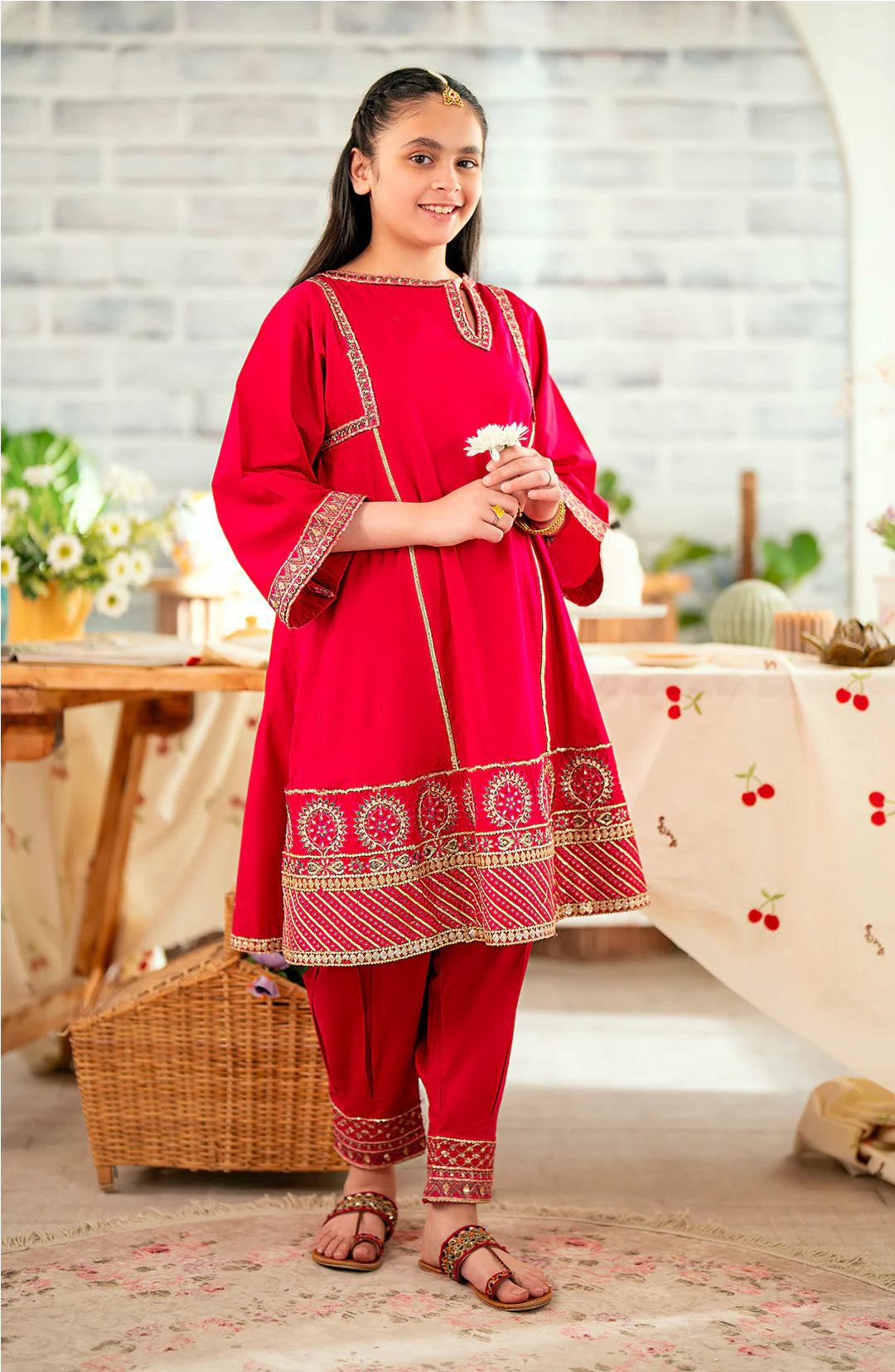  A girl aged 8-10 years wearing Maryum & Maria pink peacock embroidered lawn suit – a refined choice for Pakistani suits online in Canada.